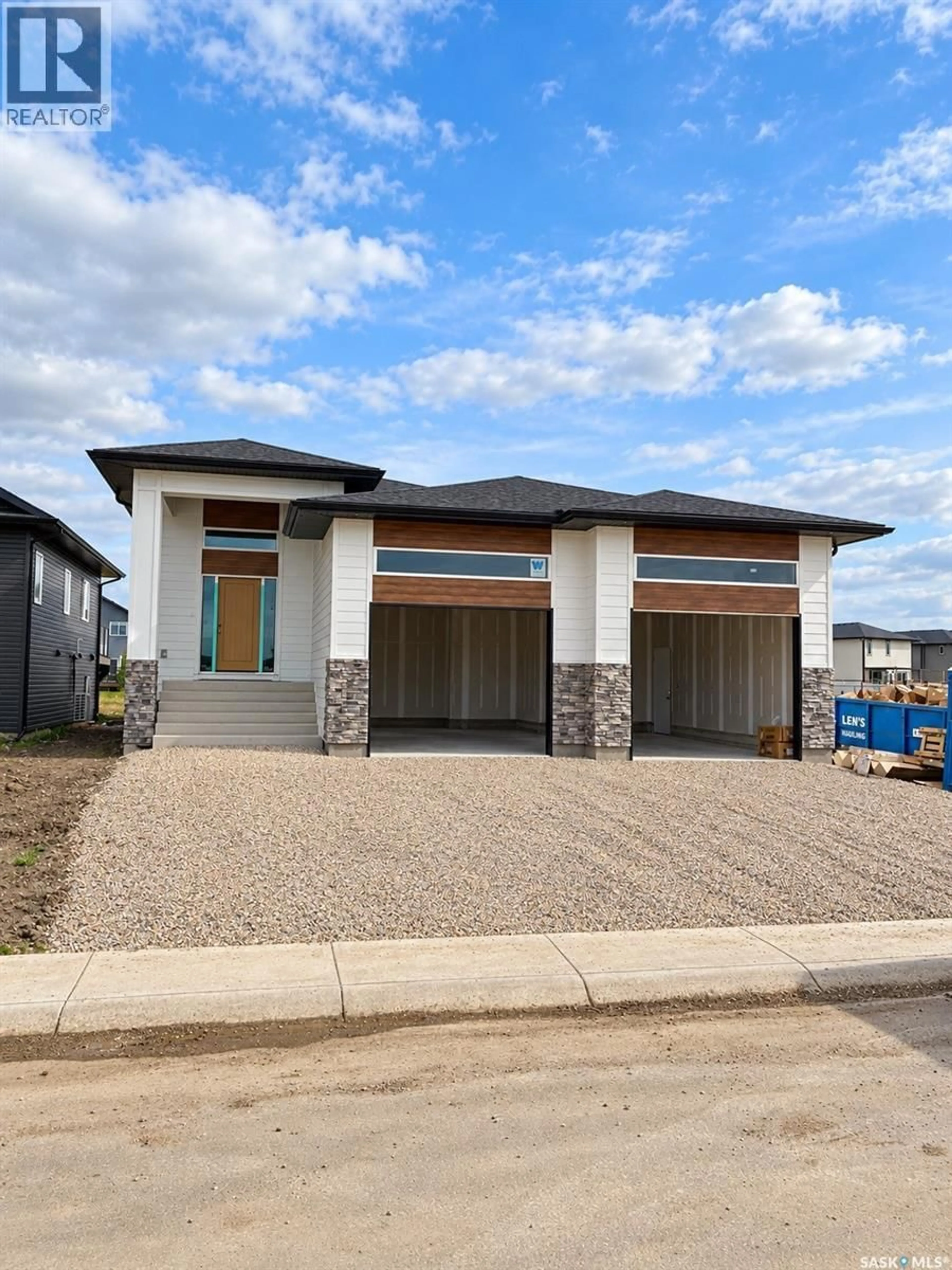 Home with brick exterior material, street for 211 DZIADYK MANOR, Saskatoon Saskatchewan S7V1V2