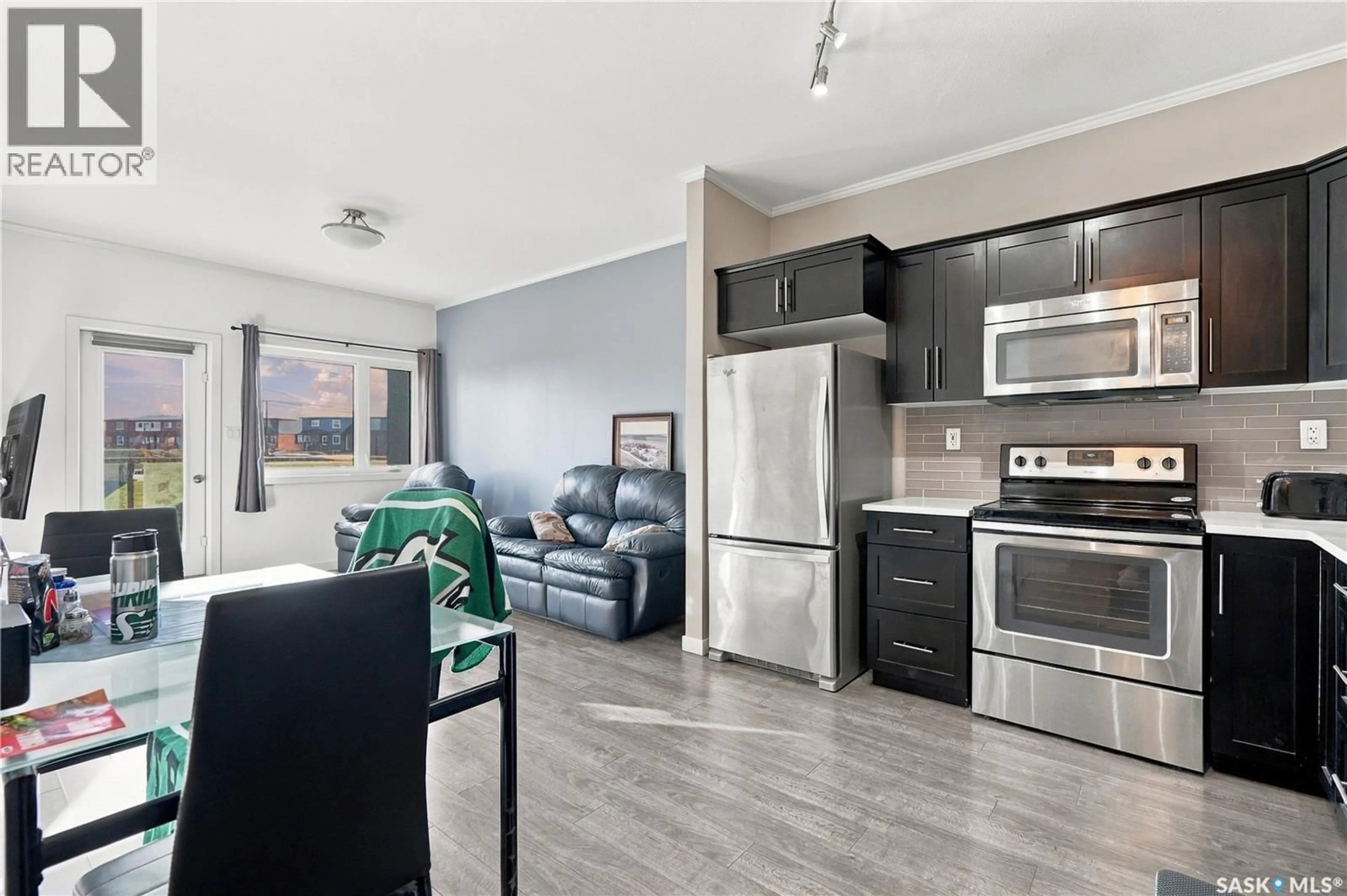 Open concept kitchen, wood/laminate floor for 108 - 720 BALTZAN BOULEVARD, Saskatoon Saskatchewan S7W0W6