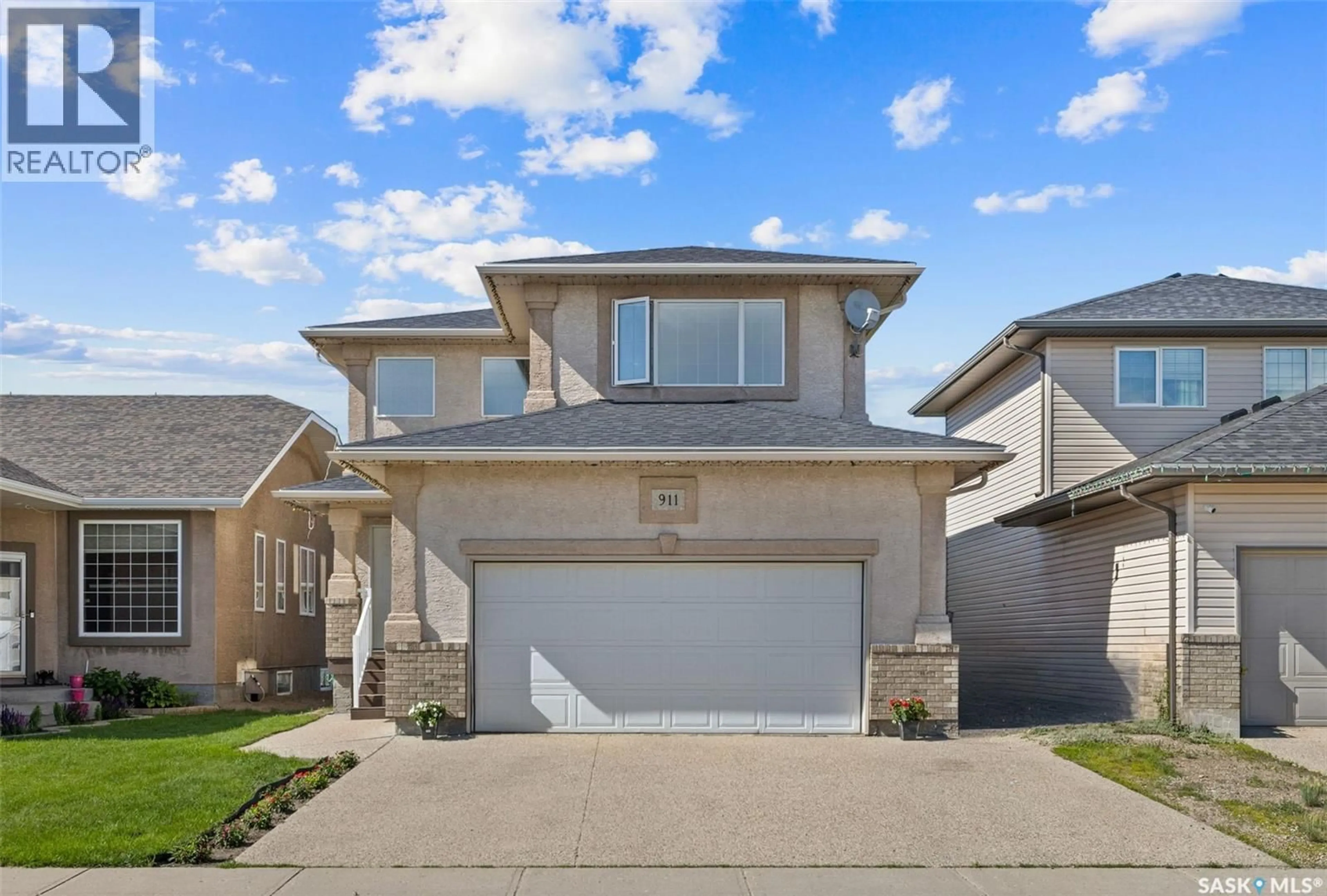 Home with vinyl exterior material, street for 911 GULL ROAD, Regina Saskatchewan S4N7P9