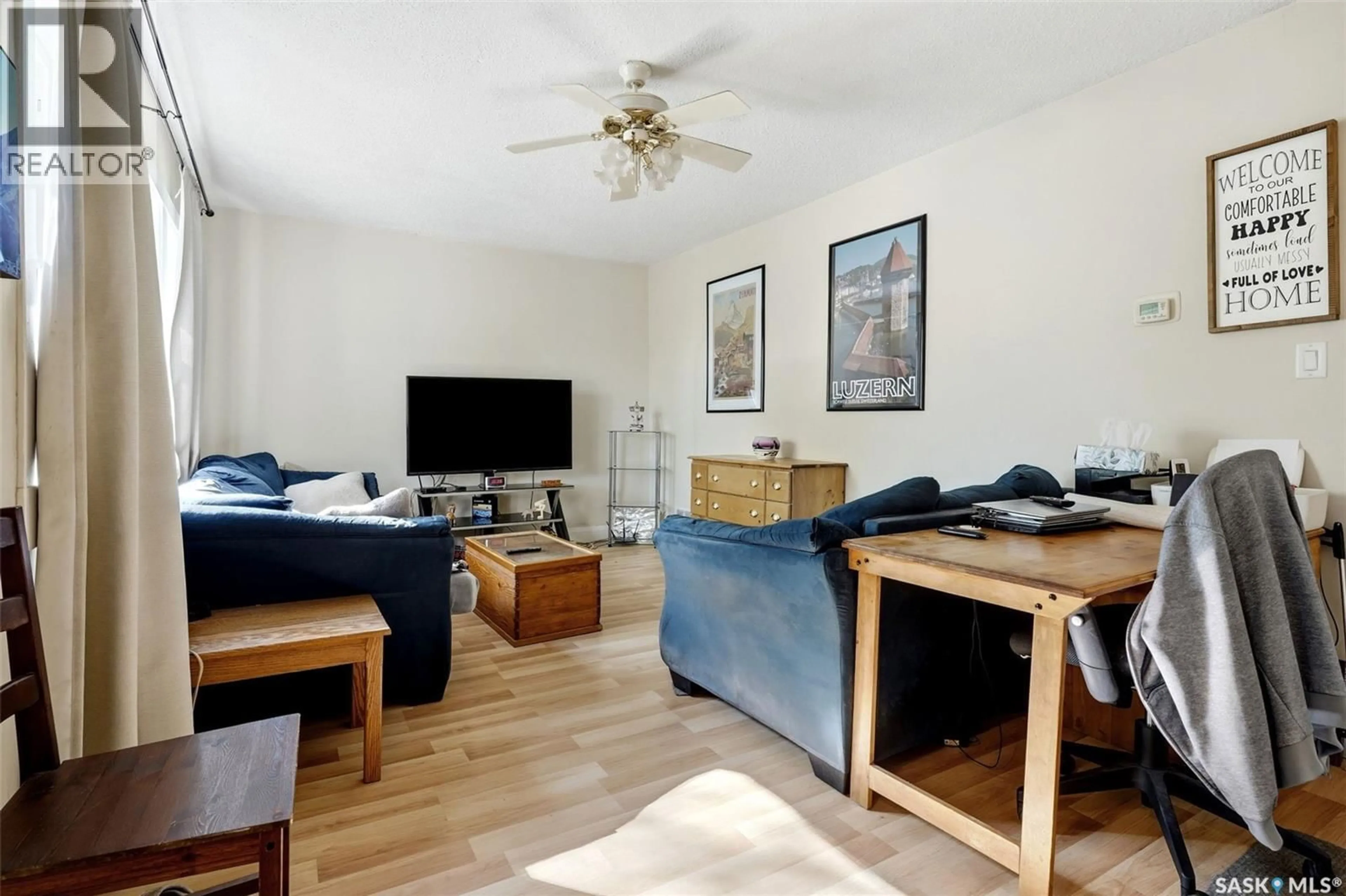 Living room with furniture, wood/laminate floor for 1010 ELPHINSTONE STREET, Regina Saskatchewan S4T3L8