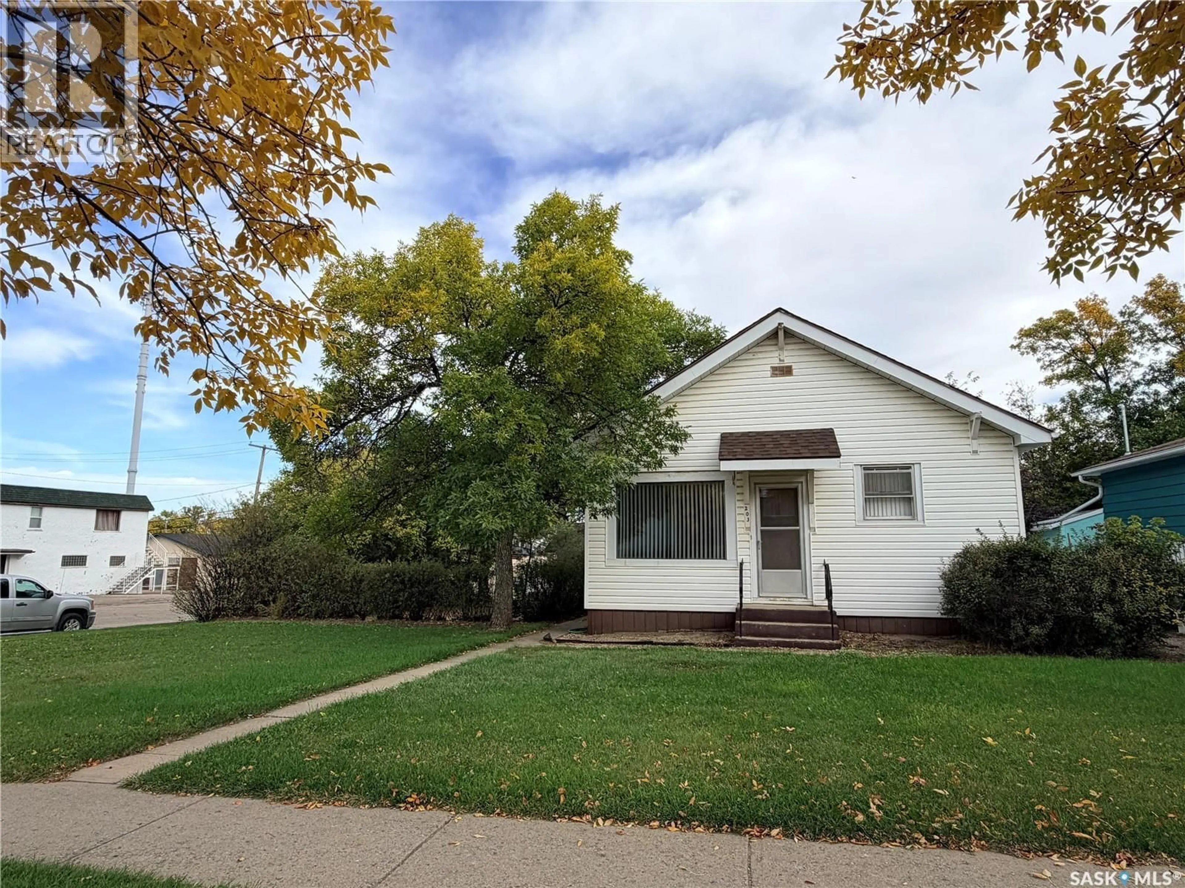 Home with vinyl exterior material, street for 203 4TH AVENUE, Assiniboia Saskatchewan S0H0B0