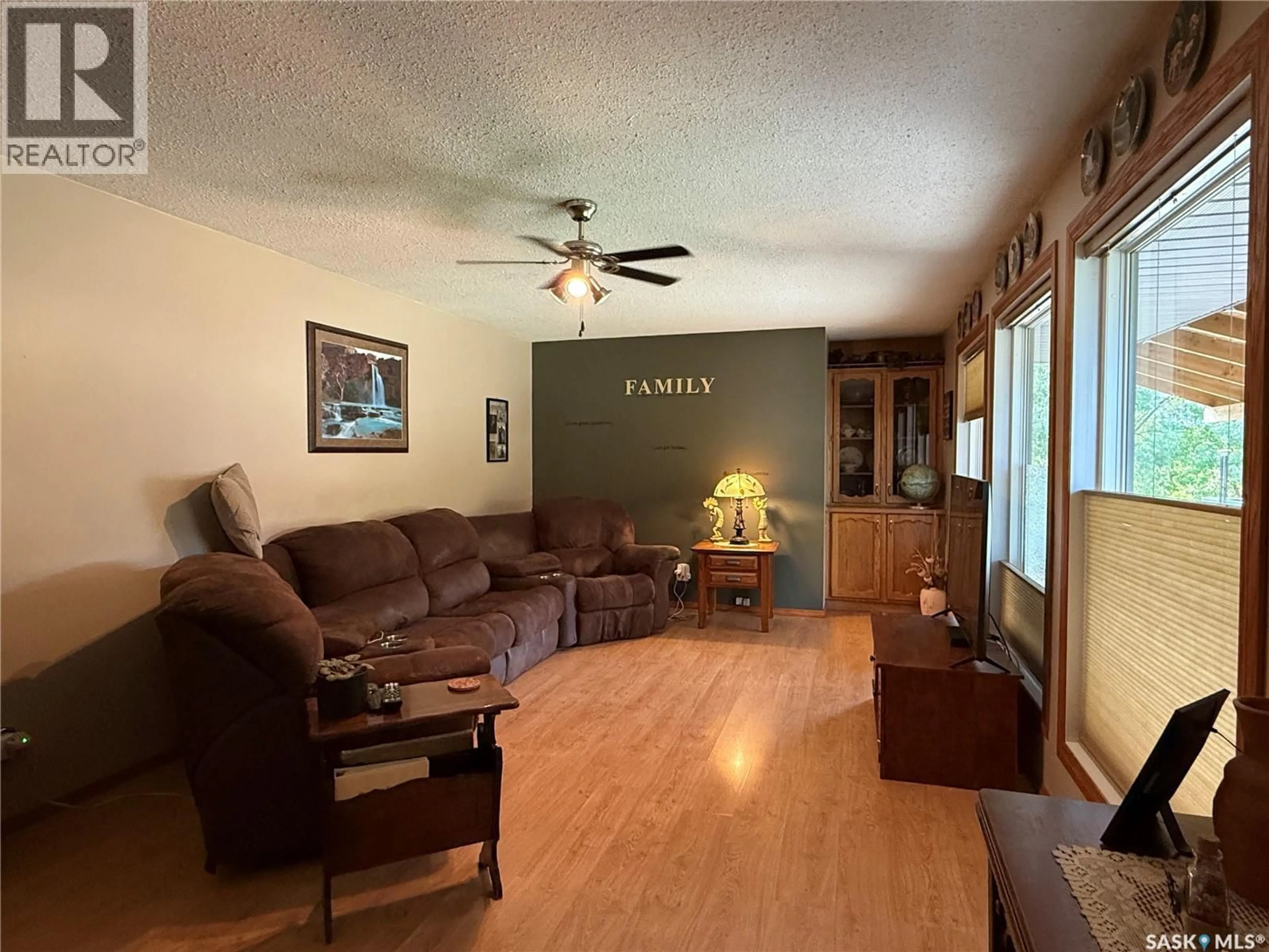 Living room with furniture, wood/laminate floor for 912 RAILWAY AVENUE, Loon Lake Saskatchewan S0M1L0