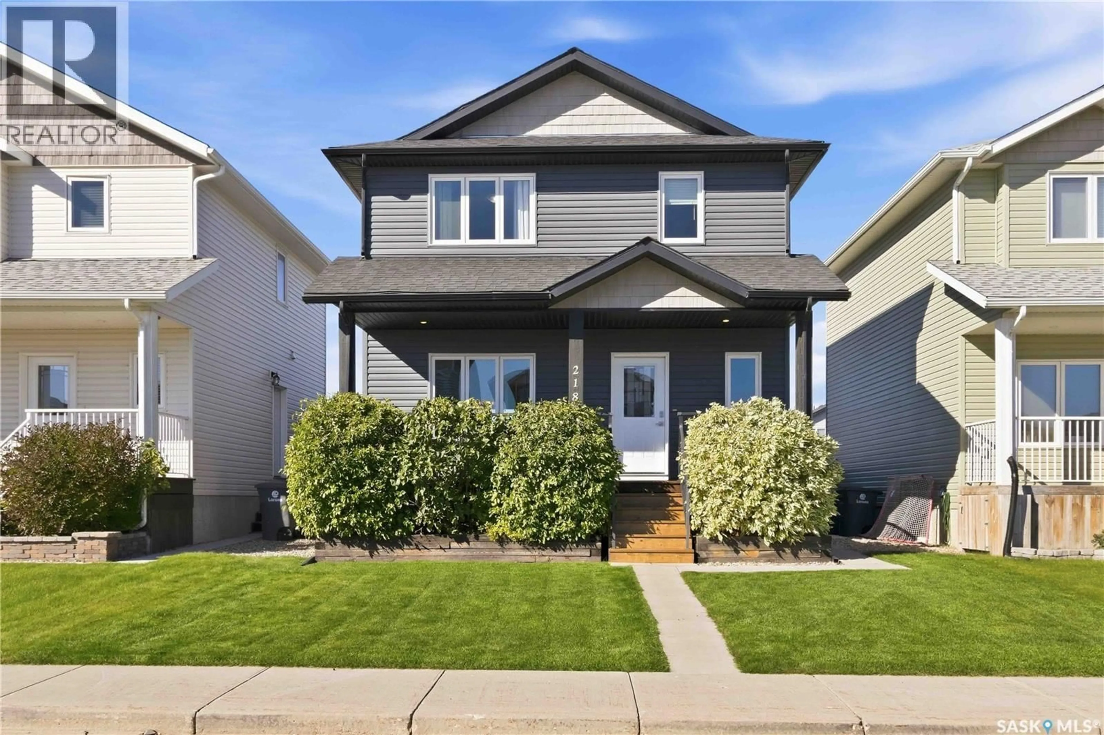 Home with vinyl exterior material, street for 218 MARTENS LANE, Warman Saskatchewan S0K4S3