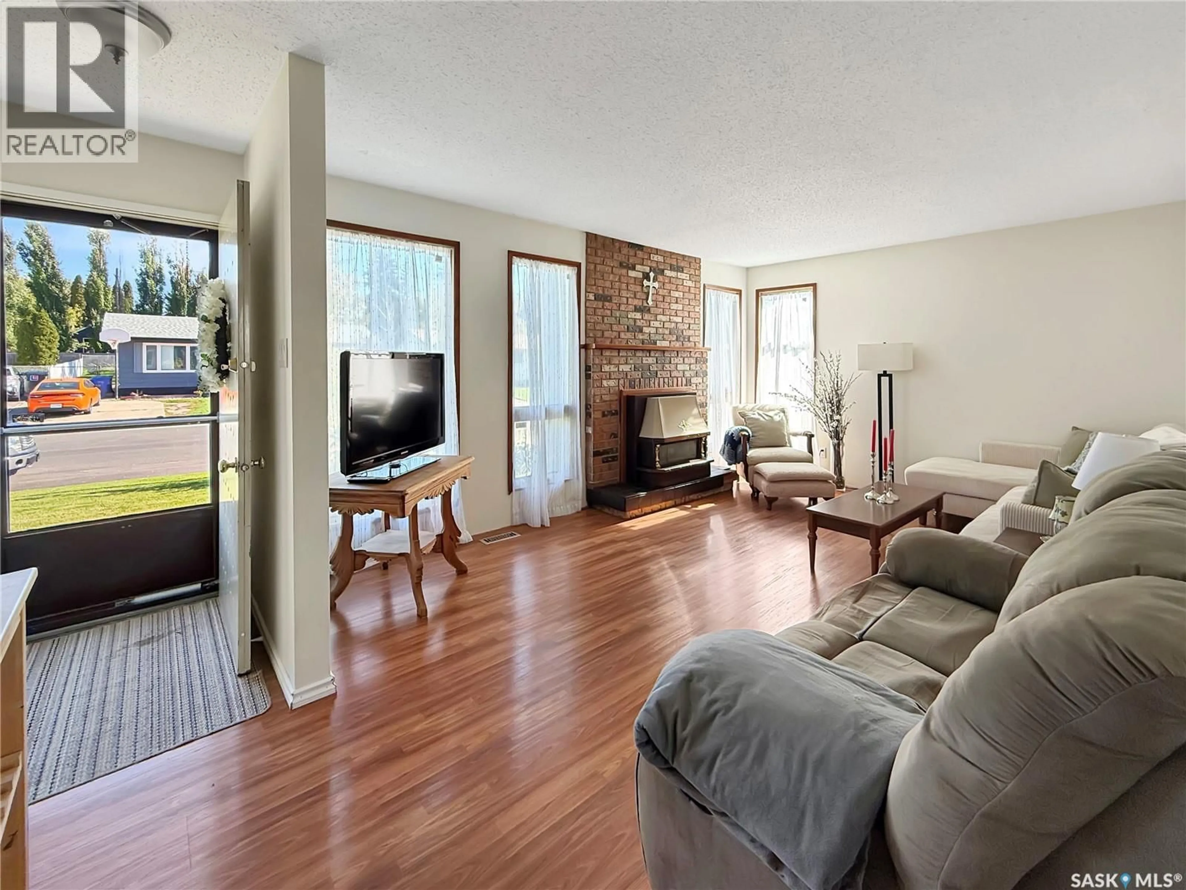 Living room with furniture, wood/laminate floor for 11033 MARTIN CRESCENT, North Battleford Saskatchewan S9A3M9