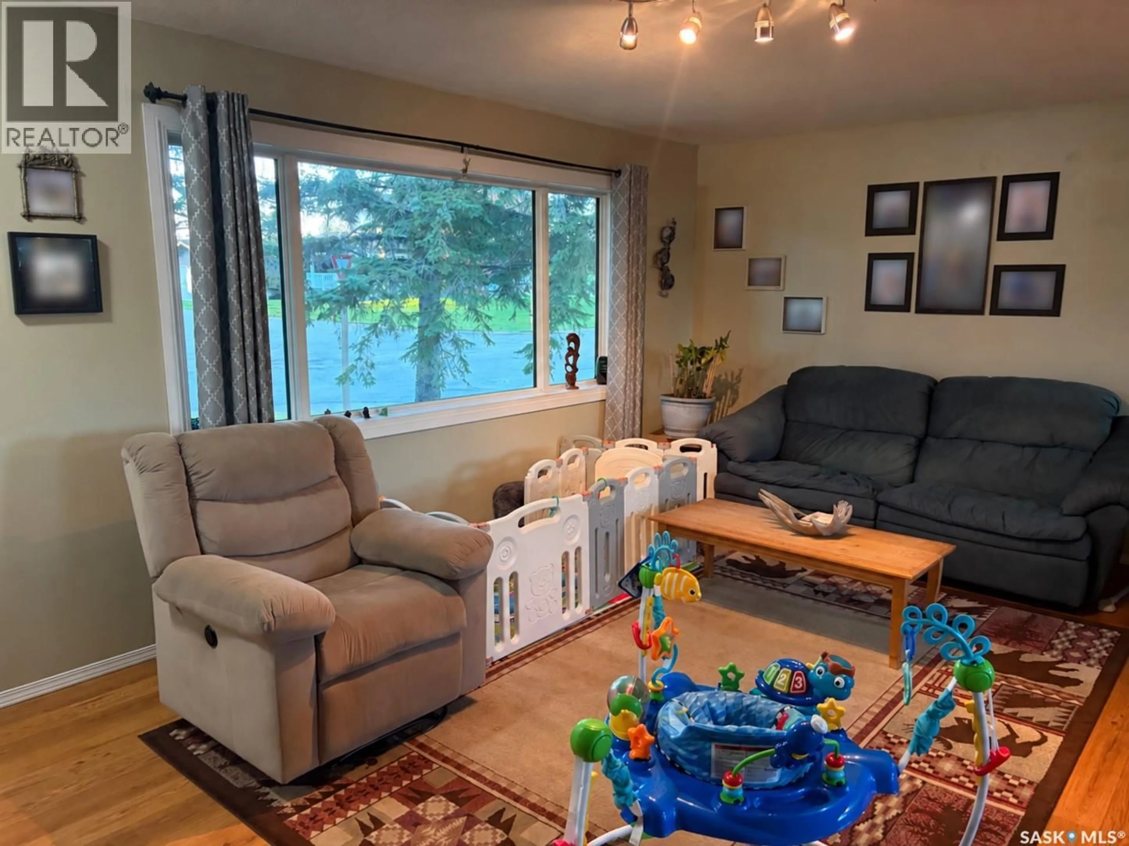 Living room with furniture, wood/laminate floor for 502 6TH STREET, Wynyard Saskatchewan S0A4T0