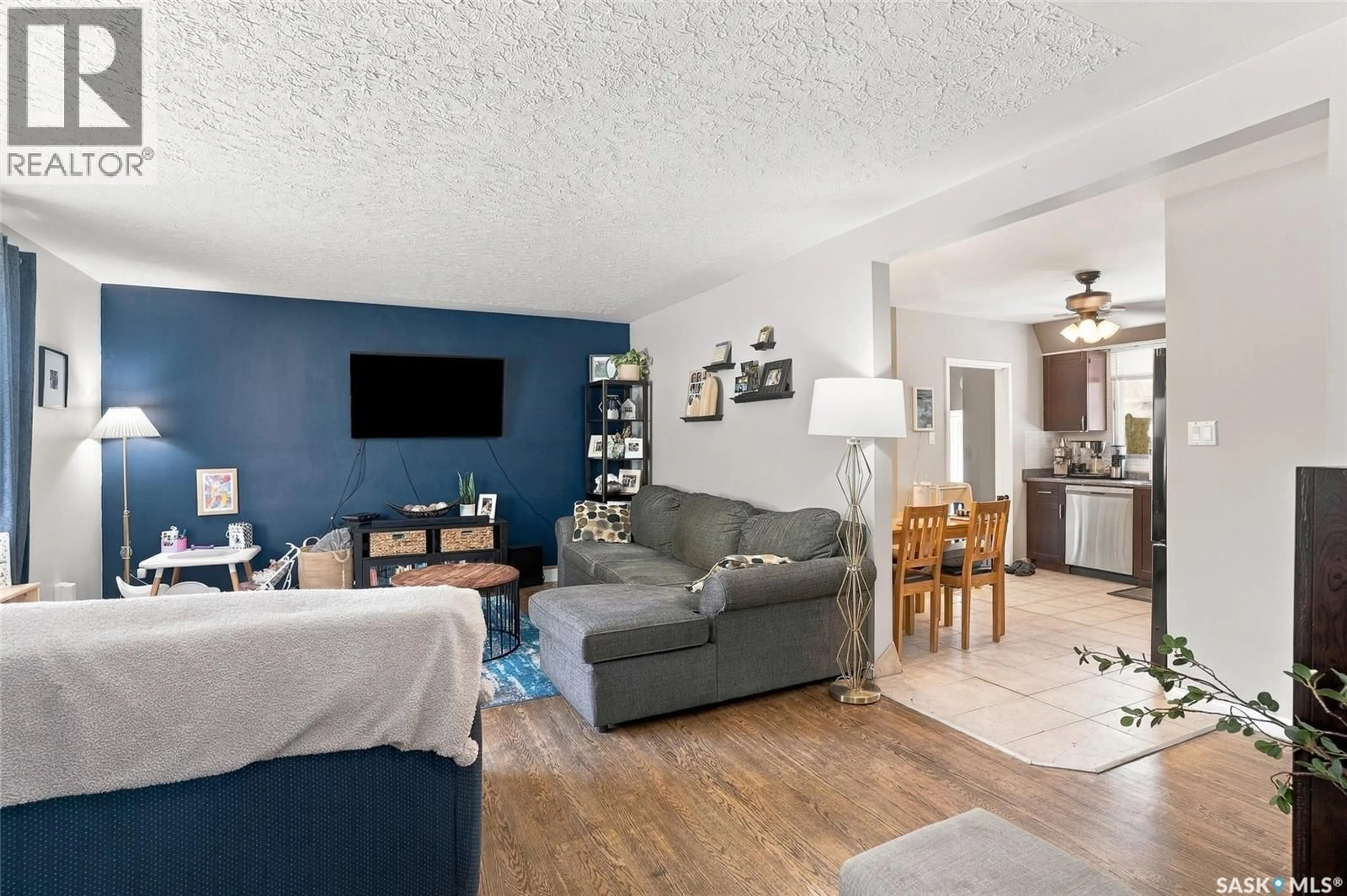 Living room with furniture, wood/laminate floor for 2518 EWART AVENUE, Saskatoon Saskatchewan S7J1Y8