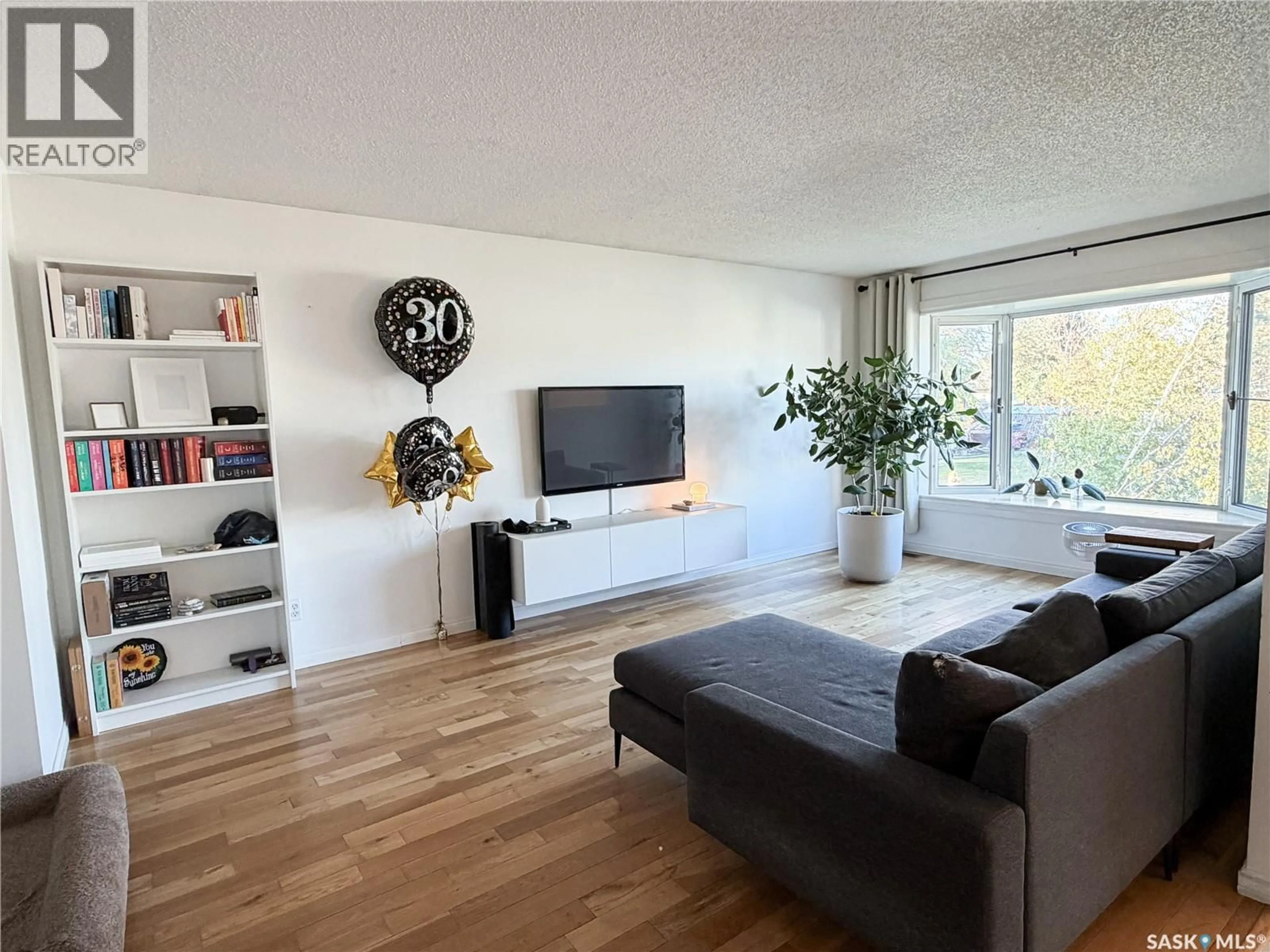 Living room with furniture, wood/laminate floor for 10 EVANS PLACE, Meadow Lake Saskatchewan S9X1A4