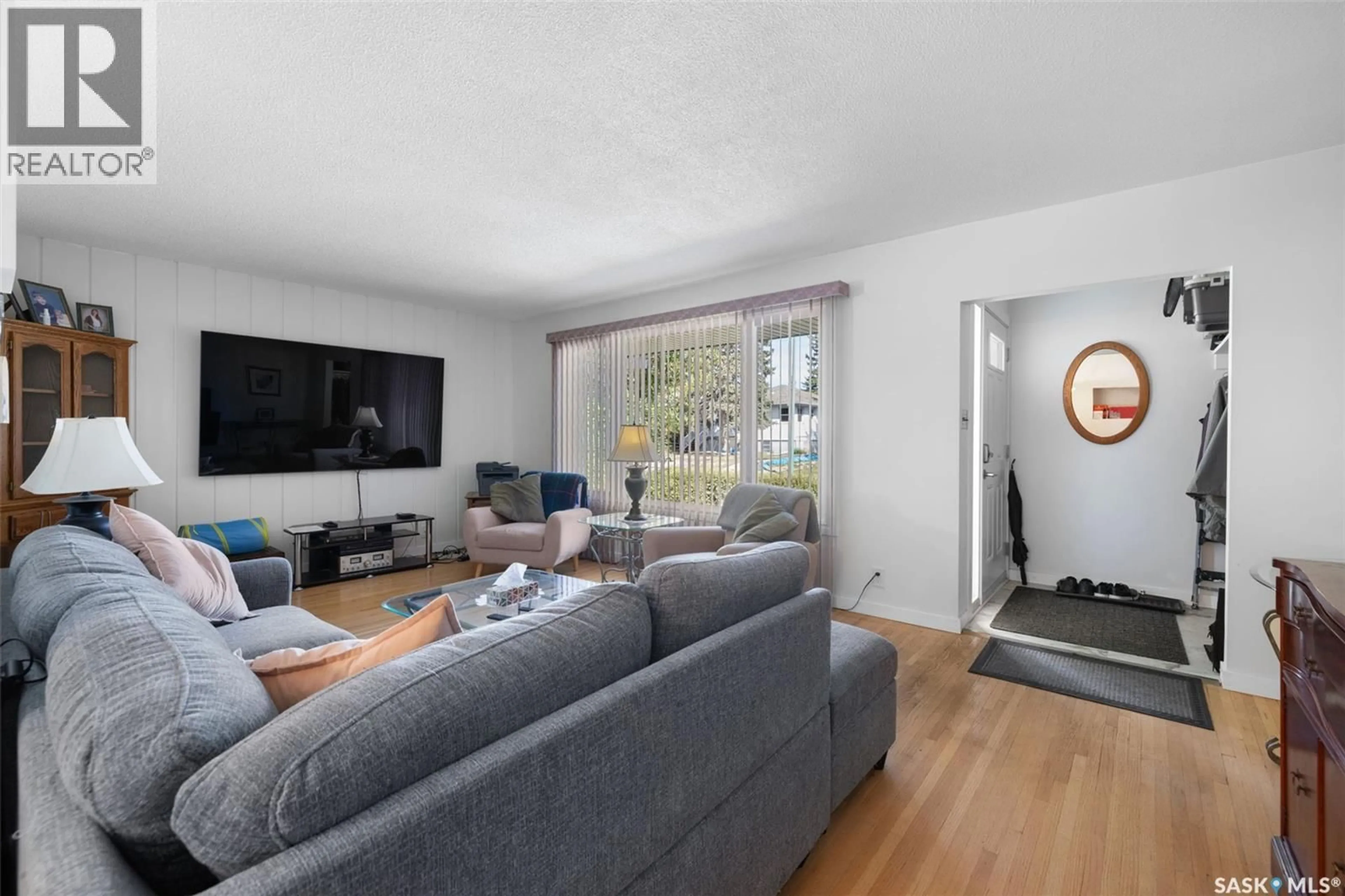 Living room with furniture, wood/laminate floor for 2122 WASCANA STREET, Regina Saskatchewan S4T4J9