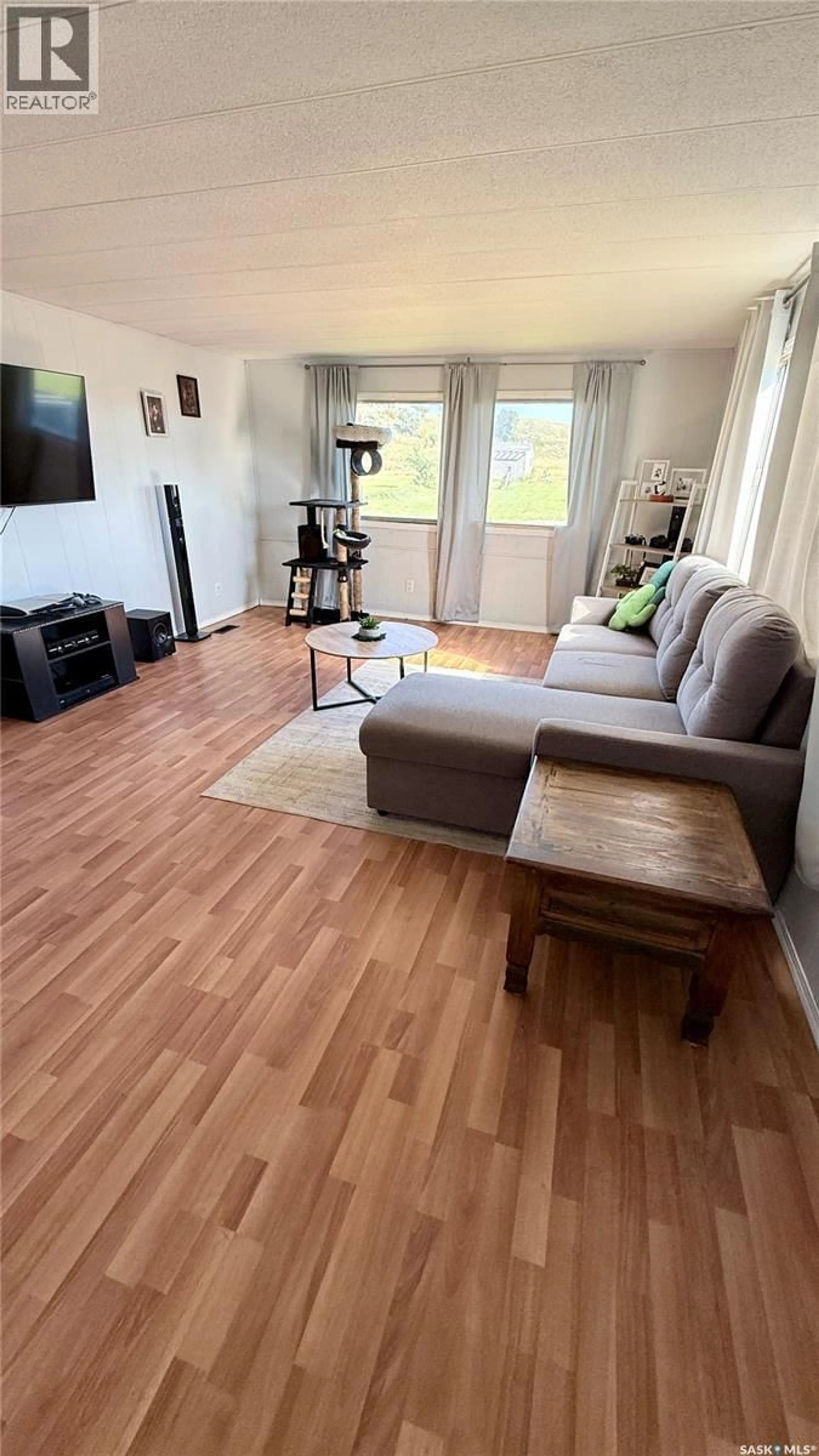 Living room with furniture, wood/laminate floor for 460 WILLOW PARK GREENS, Estevan Saskatchewan S4A2S2