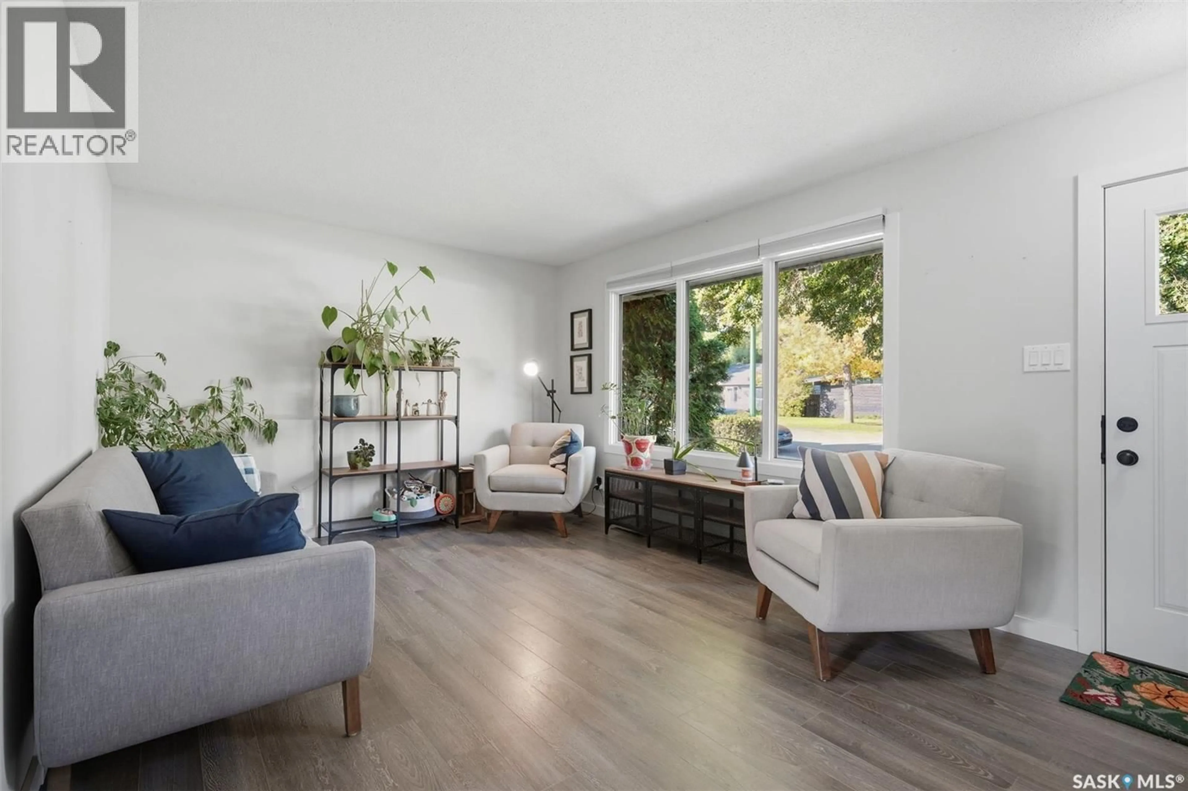 Living room with furniture, wood/laminate floor for 49 MACKENZIE CRESCENT, Saskatoon Saskatchewan S7J2R4