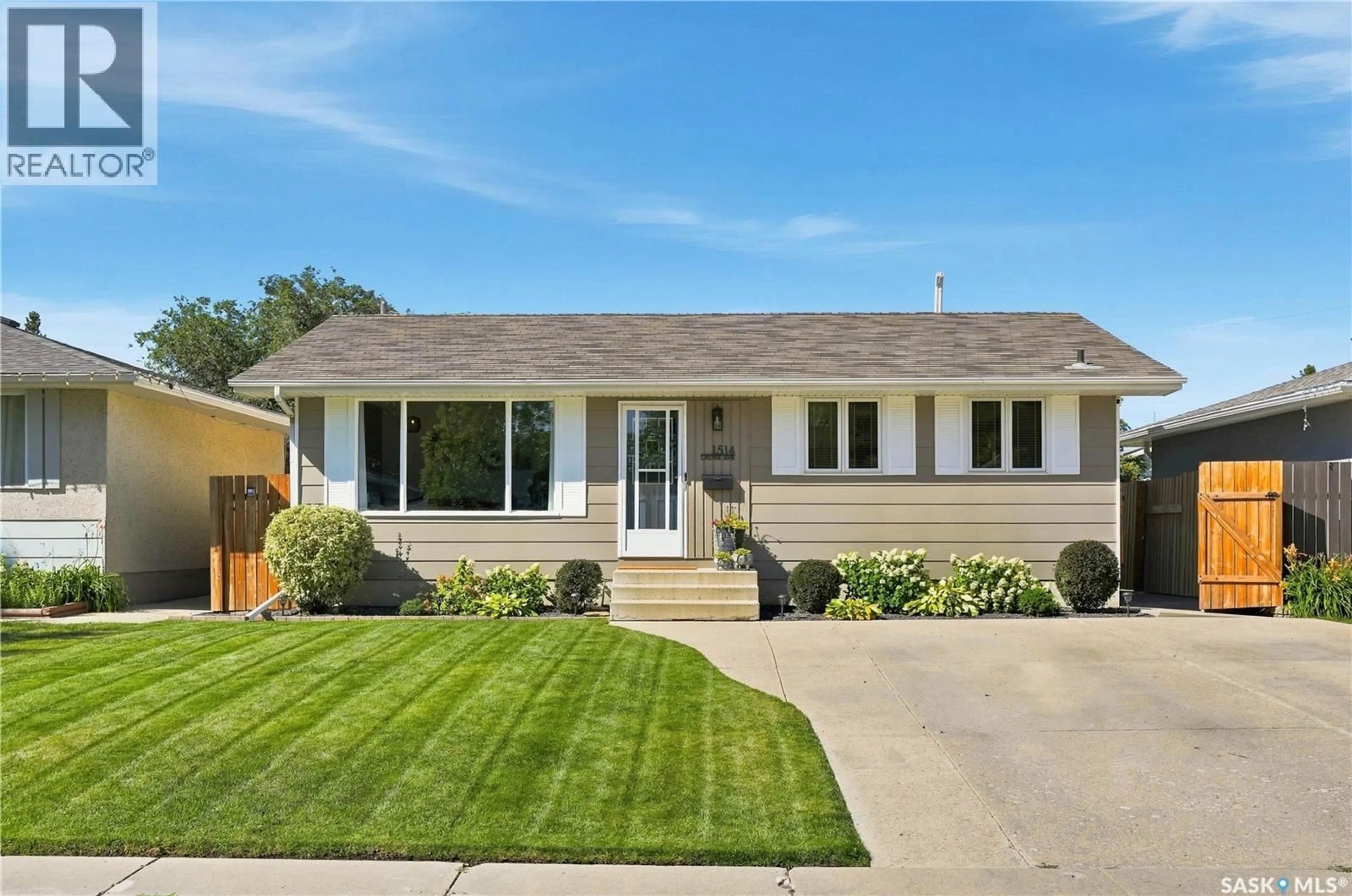 Home with vinyl exterior material, street for 1514 LAURA AVENUE, Saskatoon Saskatchewan S7N2S3