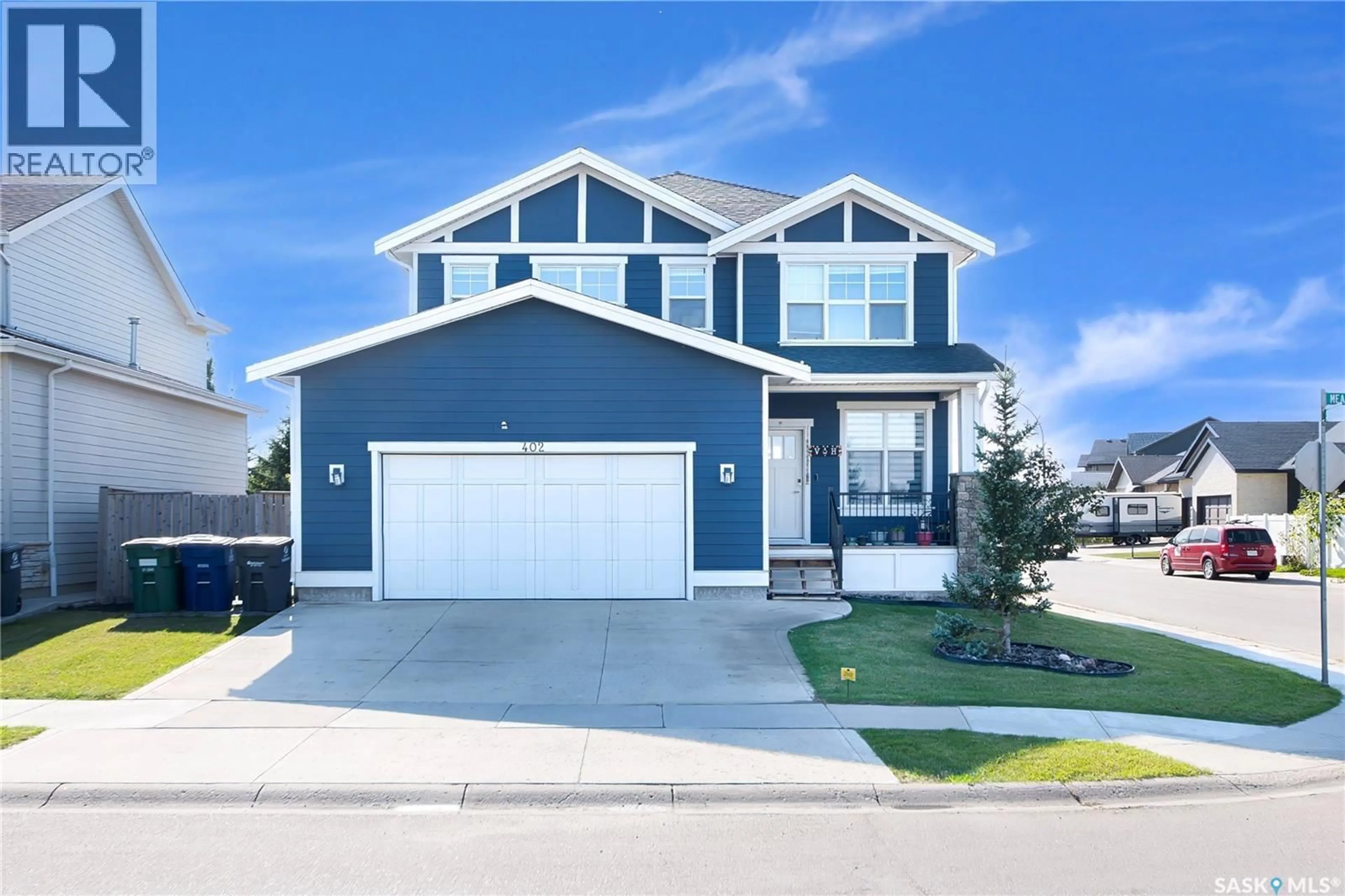 Home with vinyl exterior material, street for 402 MEADOWS BOULEVARD, Saskatoon Saskatchewan S7V0E7