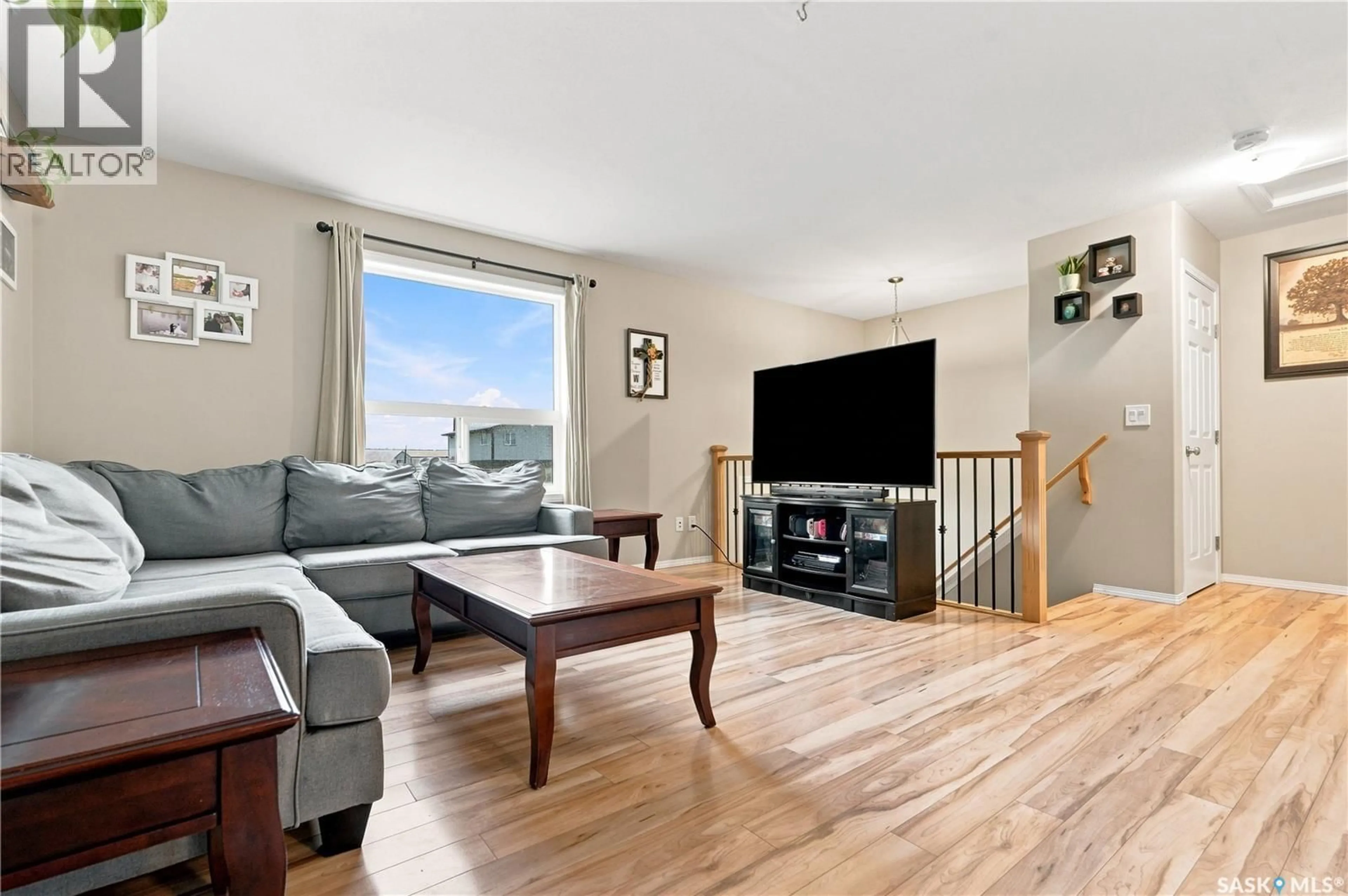 Living room with furniture, wood/laminate floor for 15 200 HIEBERT CRESCENT, Martensville Saskatchewan S0K0A2
