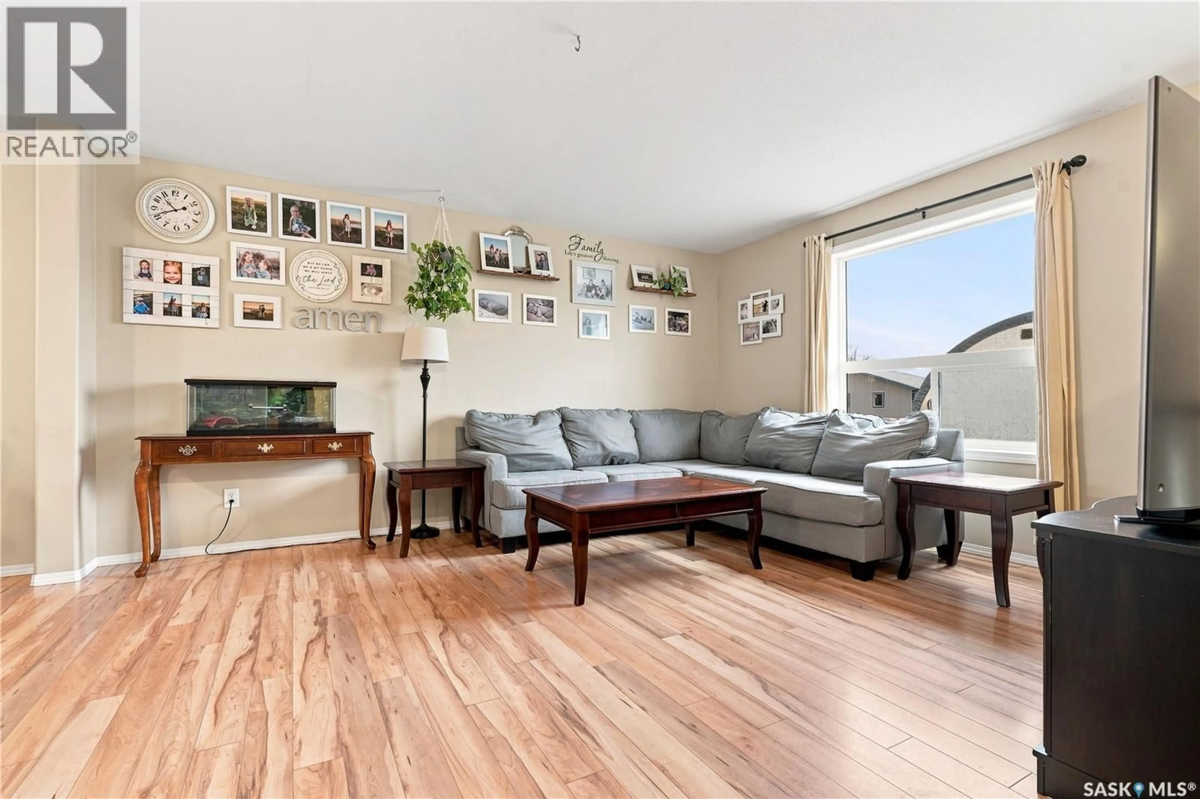 Living room with furniture, wood/laminate floor for 15 200 HIEBERT CRESCENT, Martensville Saskatchewan S0K0A2