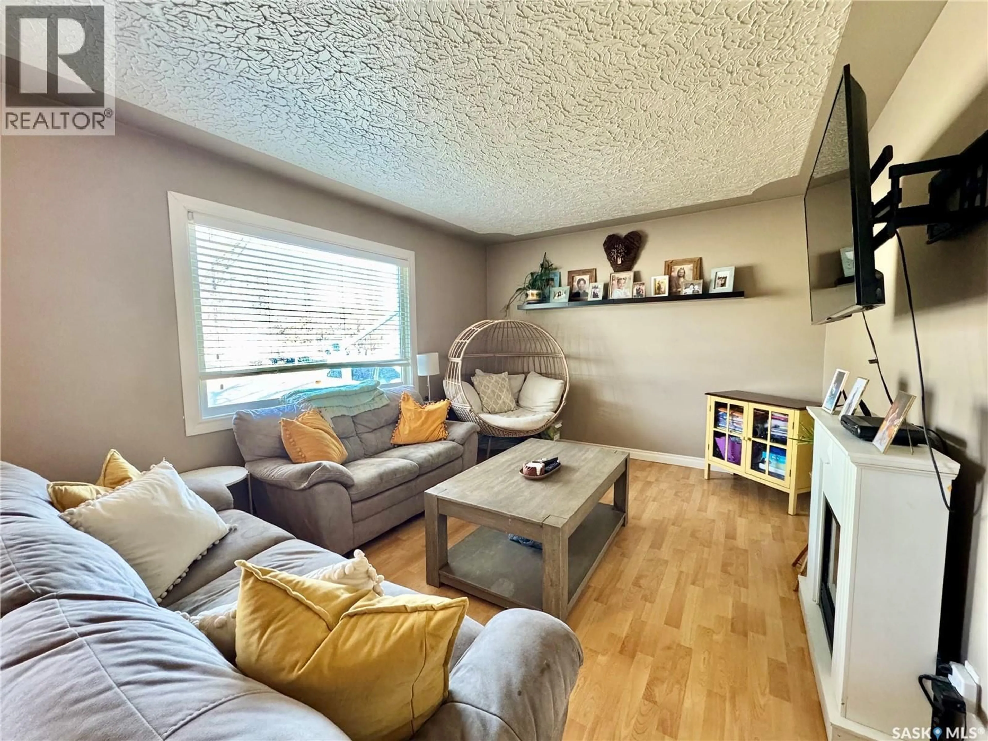Living room with furniture, wood/laminate floor for 621 23RD STREET, Prince Albert Saskatchewan S6V4M4