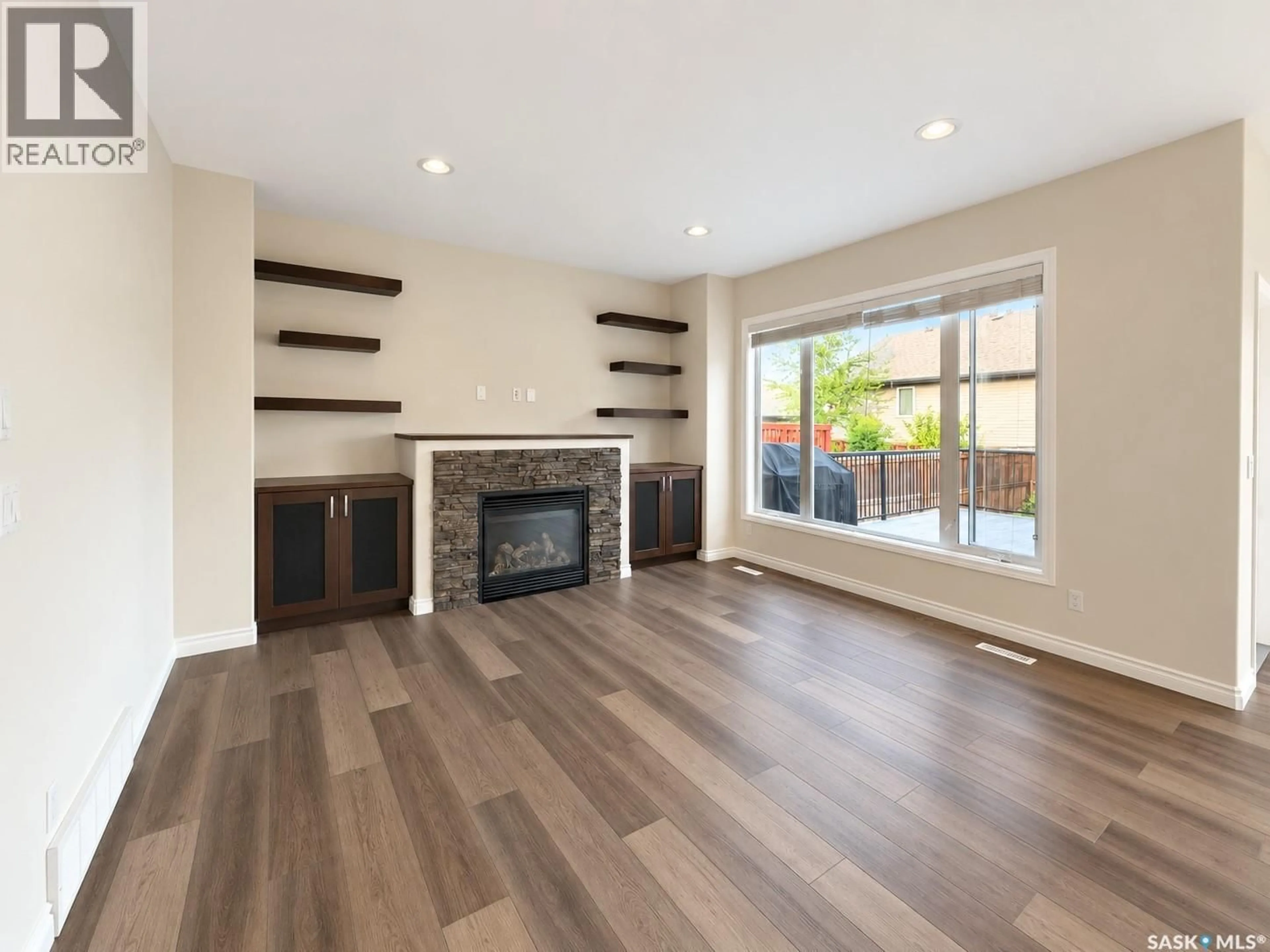 Living room with furniture, wood/laminate floor for 114 KOROL CRESCENT, Saskatoon Saskatchewan S7R0E1