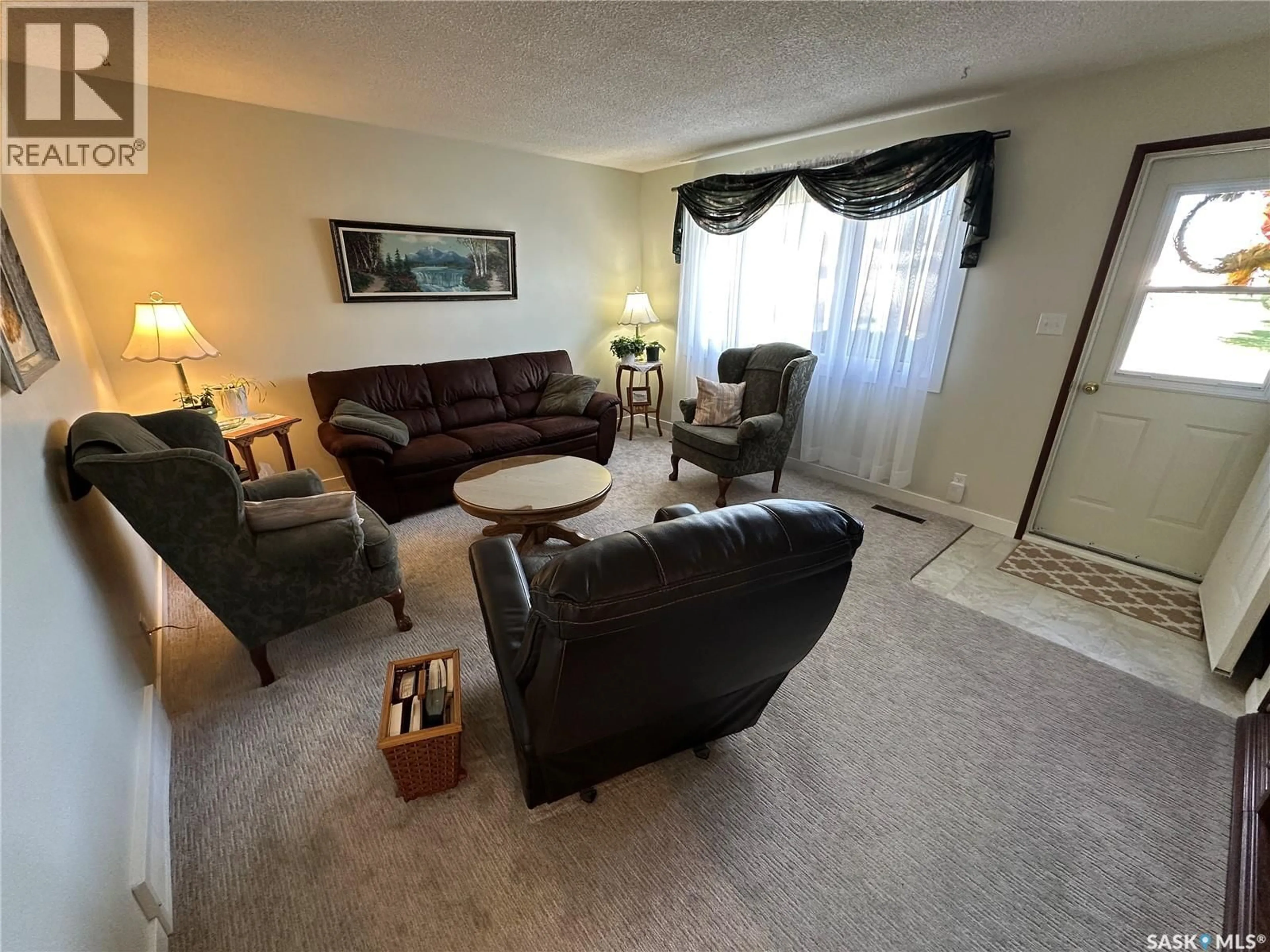 Living room with furniture, carpet floor for 8009 6TH STREET, Rosthern Saskatchewan S0K3R0