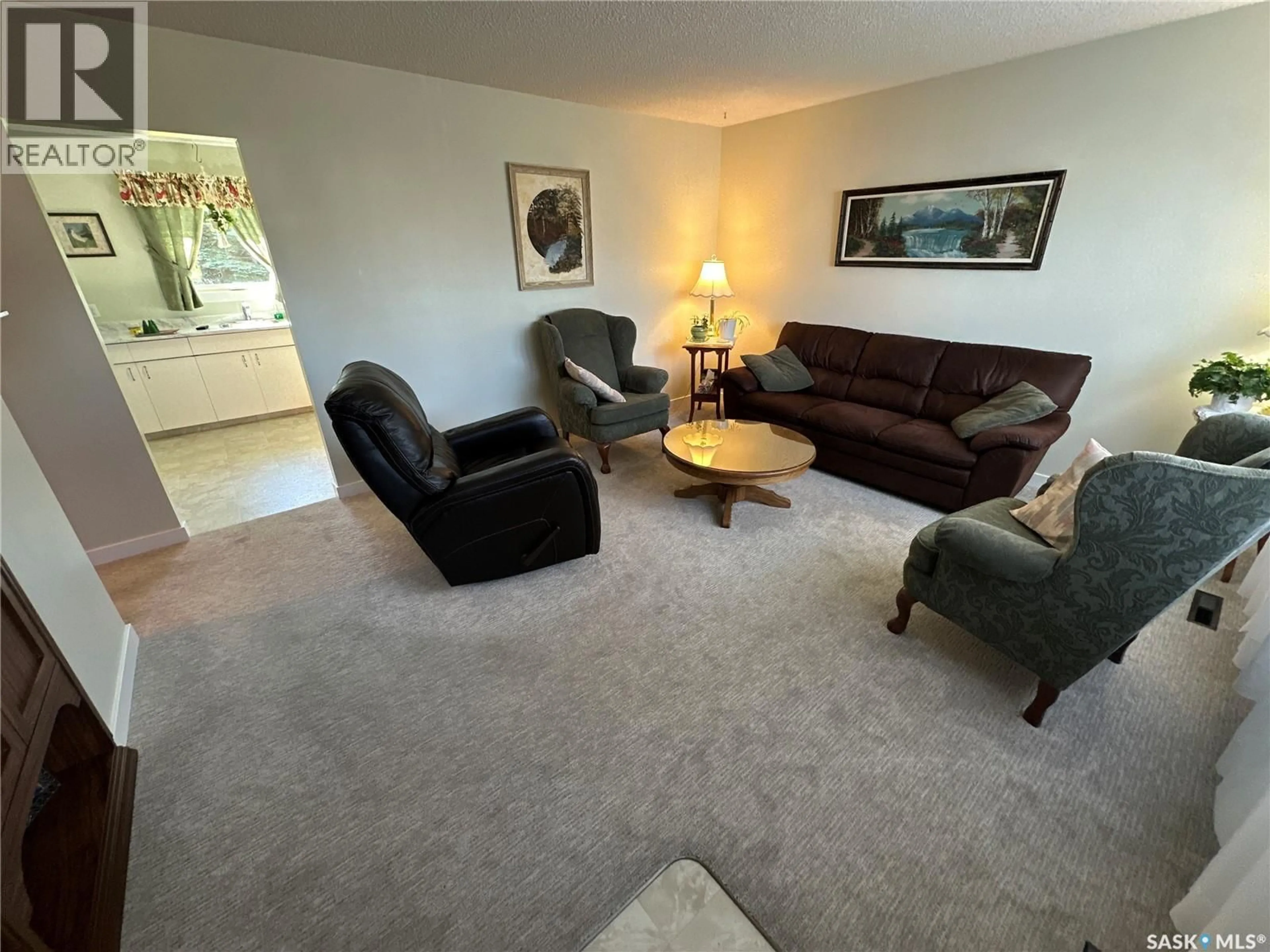 Living room with furniture, carpet floor for 8009 6TH STREET, Rosthern Saskatchewan S0K3R0