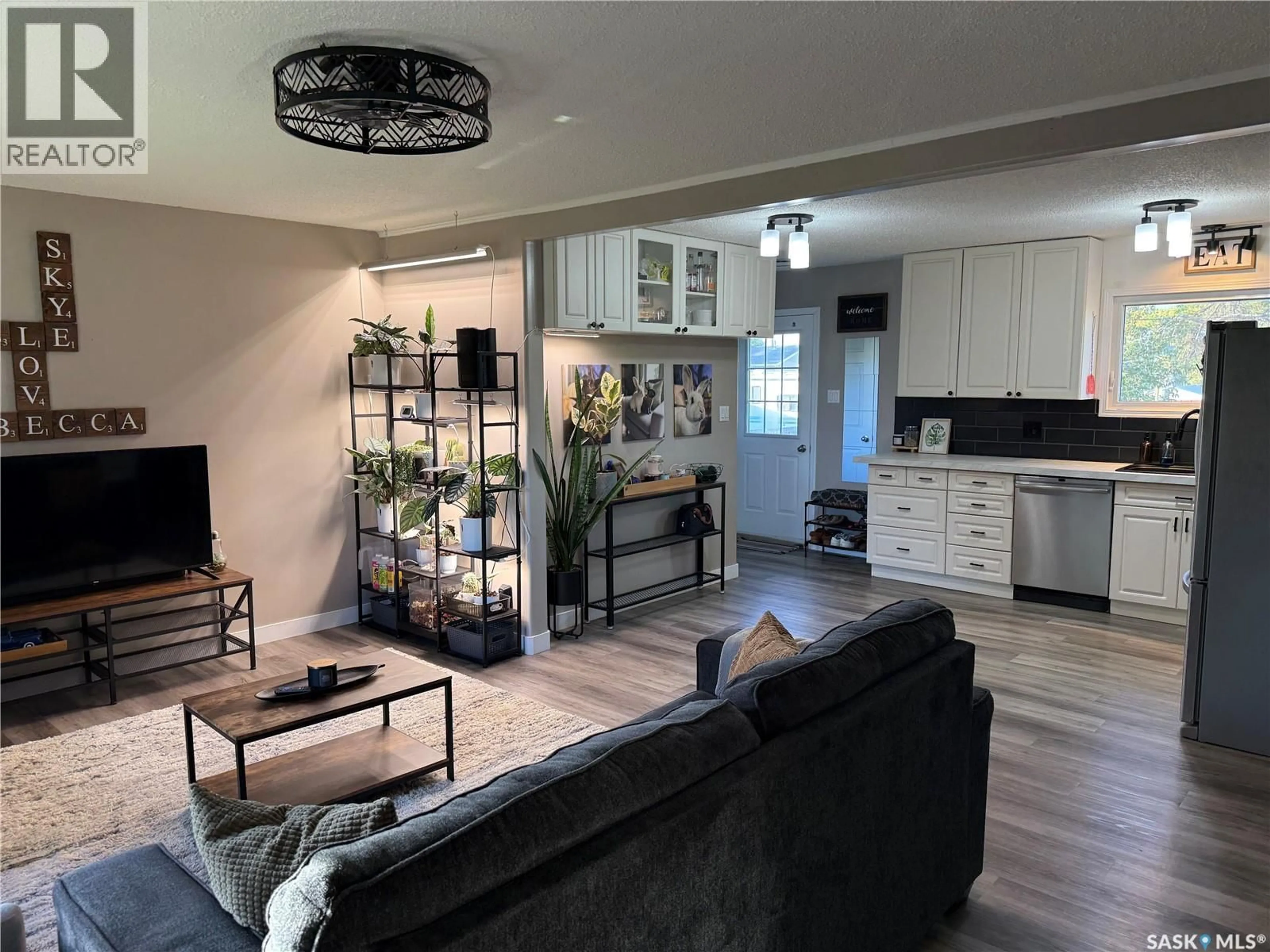 Living room with furniture, wood/laminate floor for 405 6TH AVENUE, Nipawin Saskatchewan S0E1E0