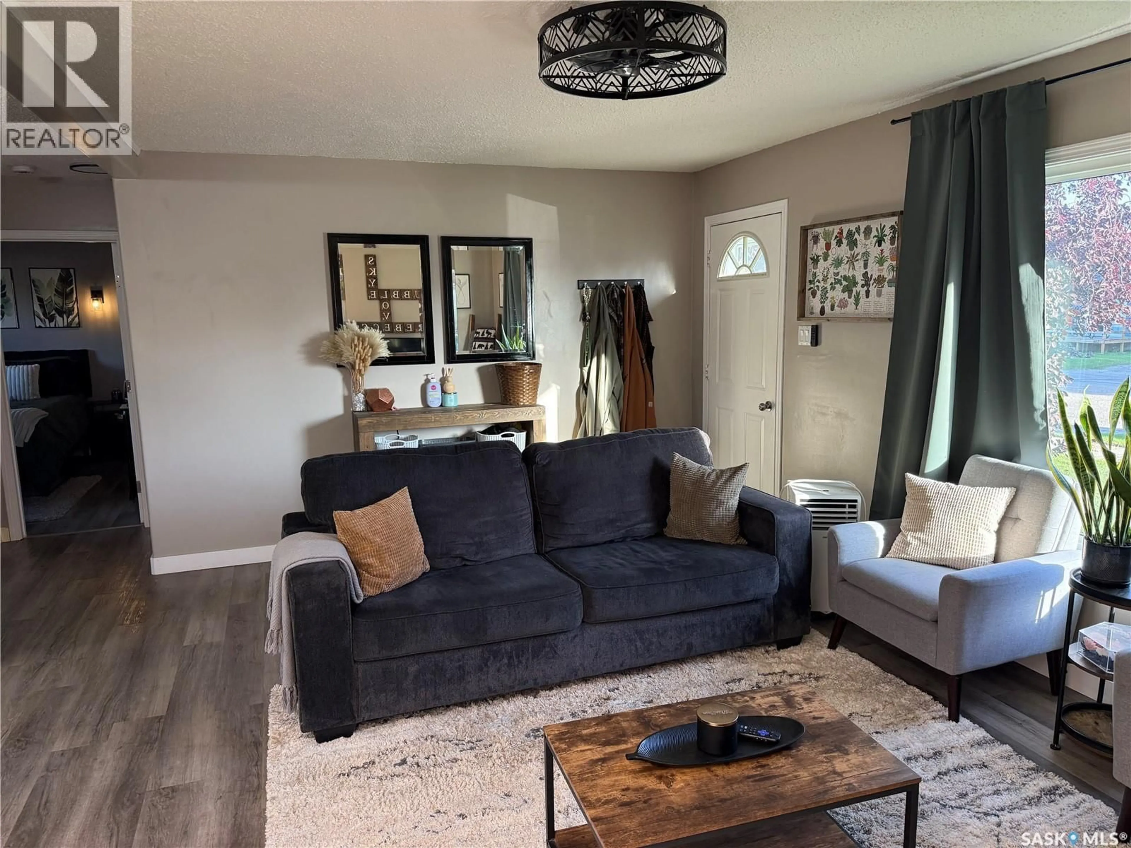 Living room with furniture, wood/laminate floor for 405 6TH AVENUE, Nipawin Saskatchewan S0E1E0