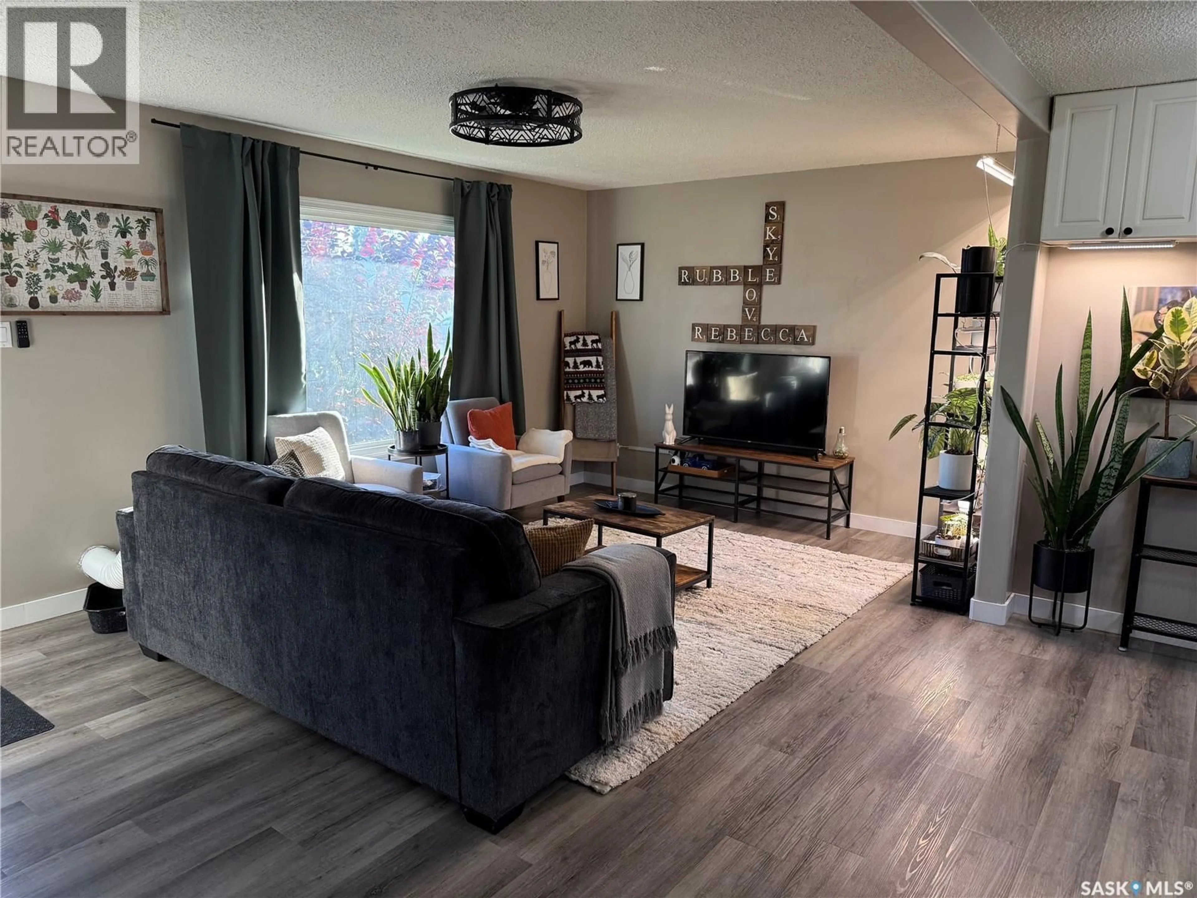 Living room with furniture, wood/laminate floor for 405 6TH AVENUE, Nipawin Saskatchewan S0E1E0