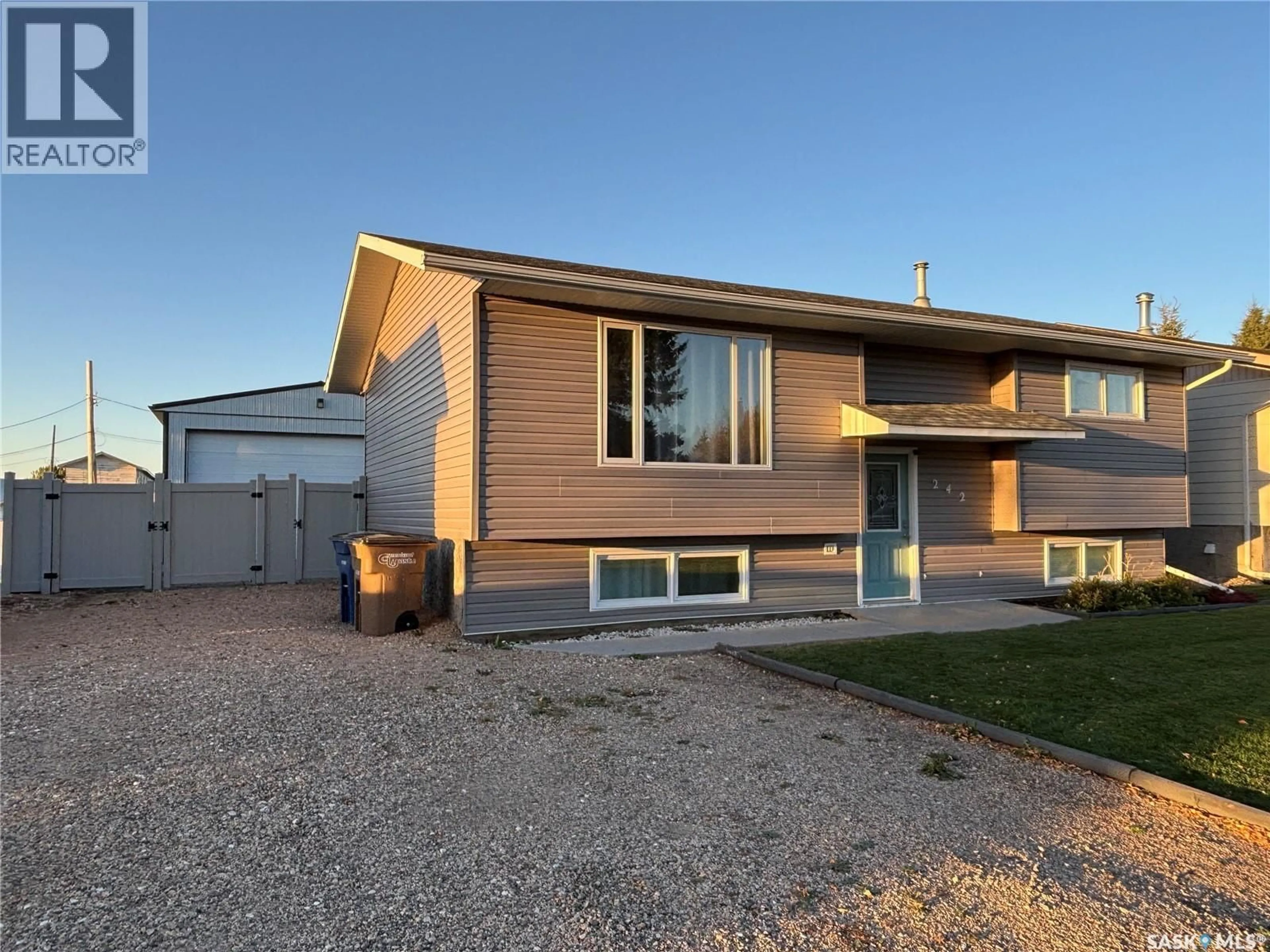 Home with vinyl exterior material, street for 242 LENDRUM STREET, Melfort Saskatchewan S0E1A0