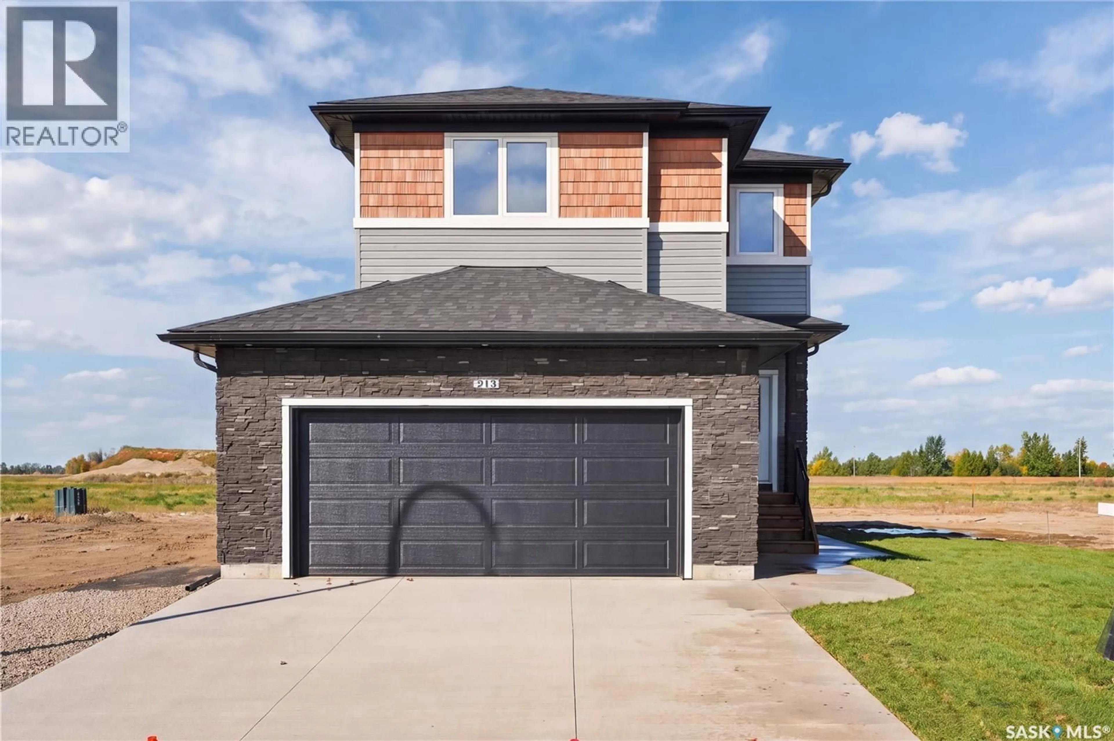 Home with brick exterior material, street for 213 VETERANS DRIVE, Warman Saskatchewan S0K4S5