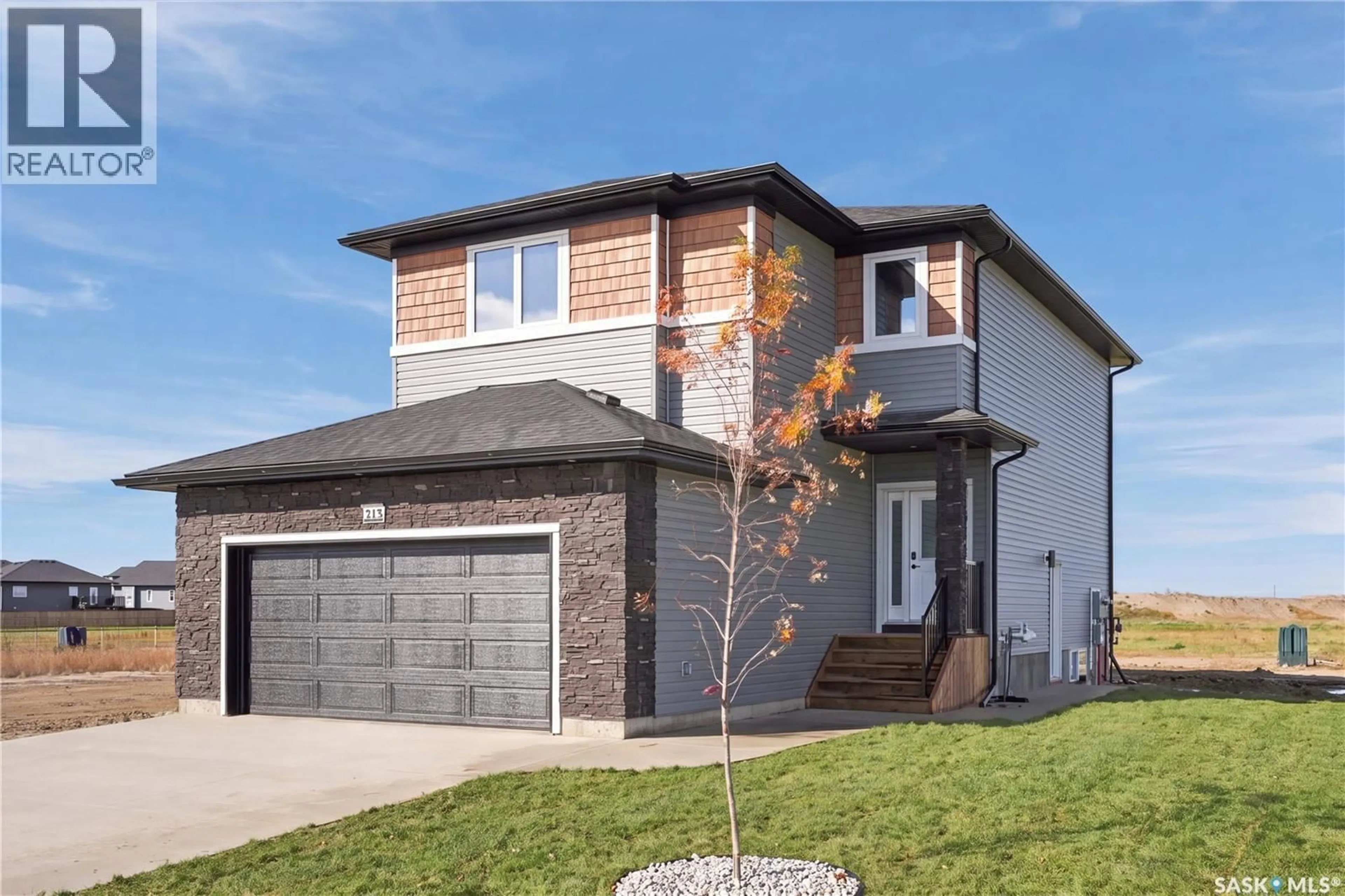 Home with brick exterior material, street for 213 VETERANS DRIVE, Warman Saskatchewan S0K4S5
