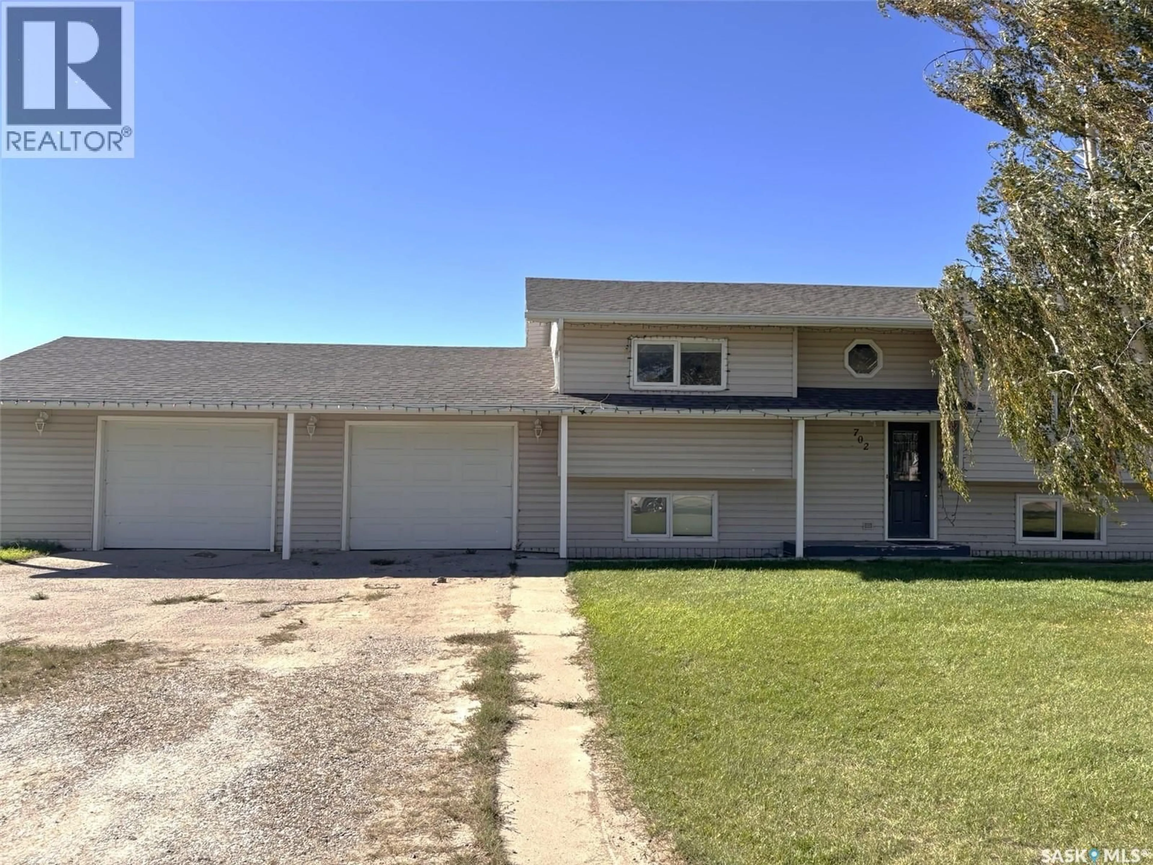 Home with vinyl exterior material, street for 702 2ND STREET, Hanley Saskatchewan S0G2E0