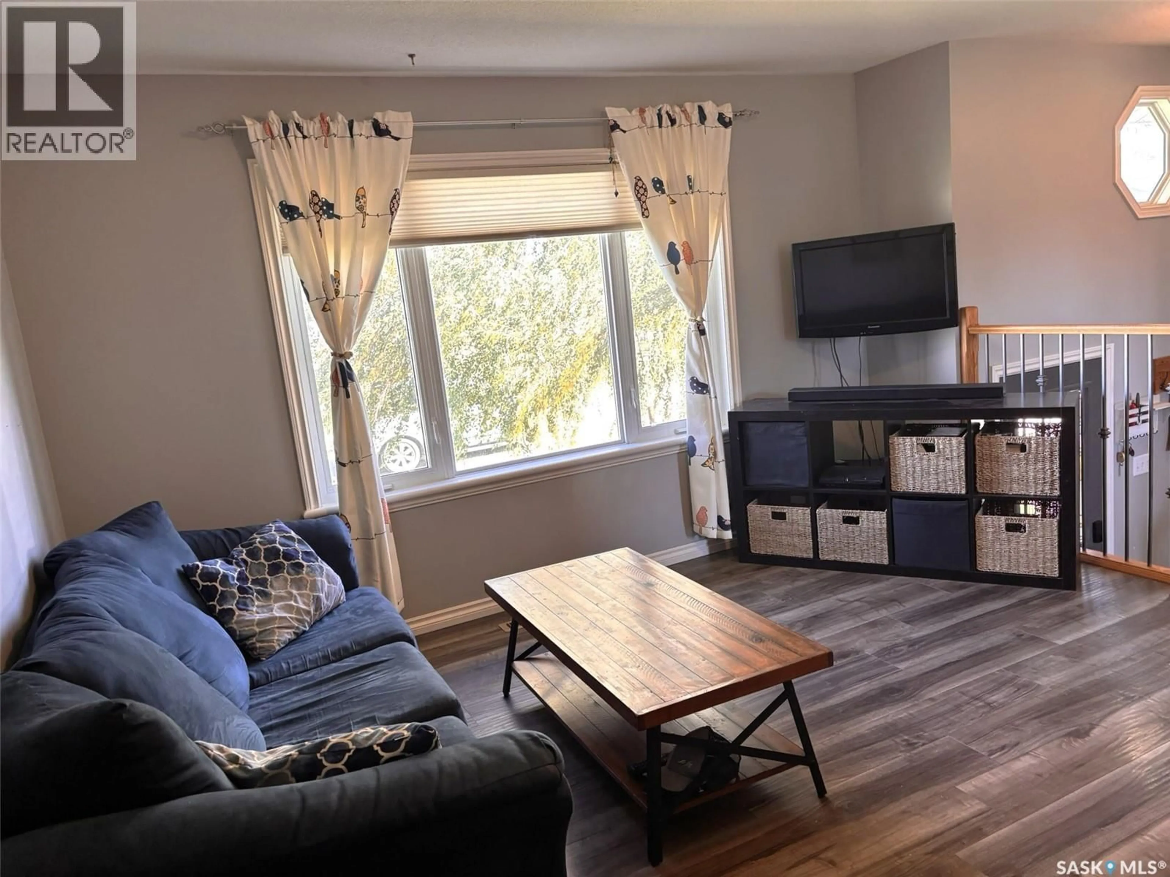 Living room with furniture, wood/laminate floor for 702 2ND STREET, Hanley Saskatchewan S0G2E0