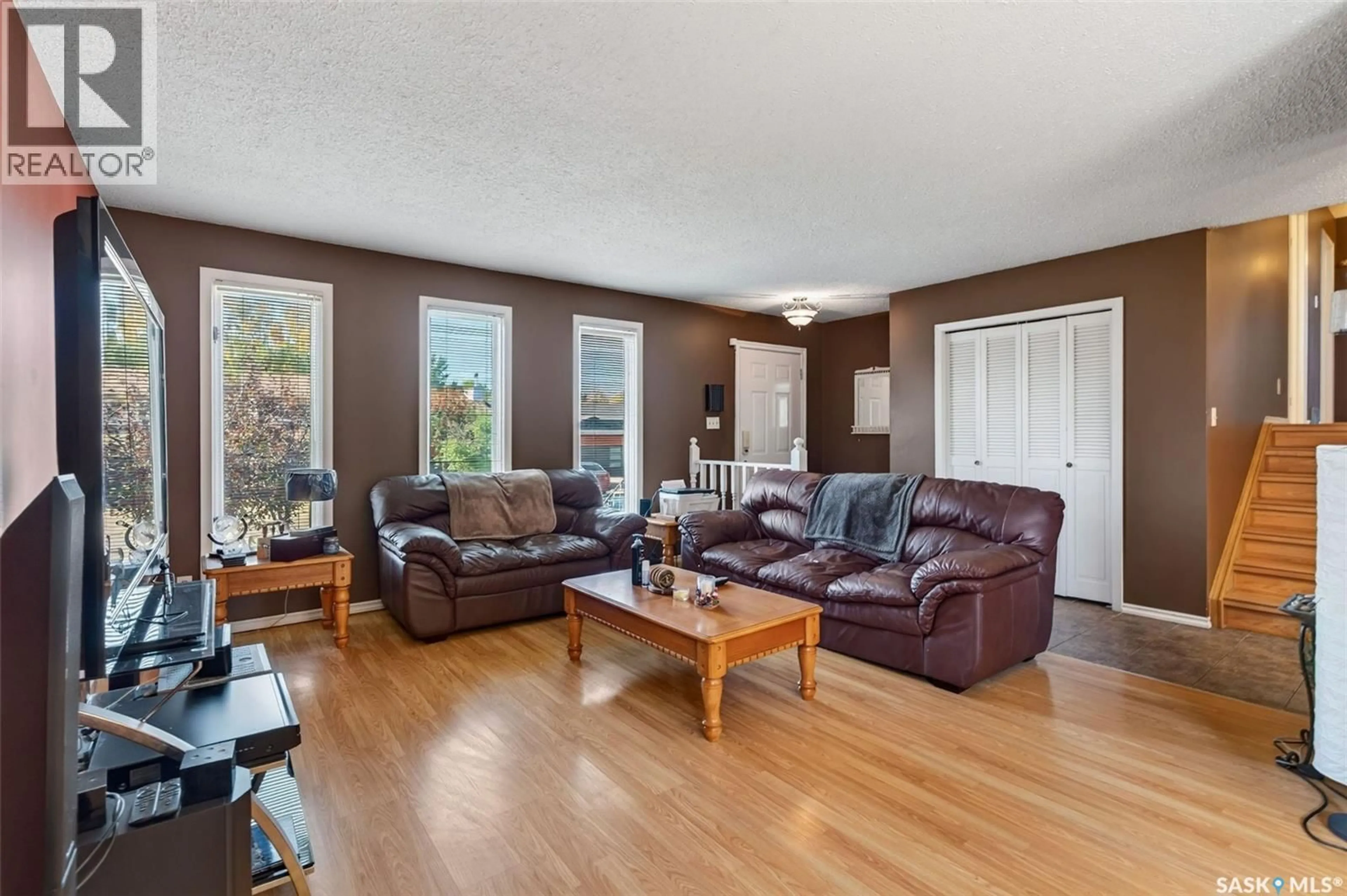 Living room with furniture, wood/laminate floor for 3458 EAGLE CRESCENT, Prince Albert Saskatchewan S6V7W9