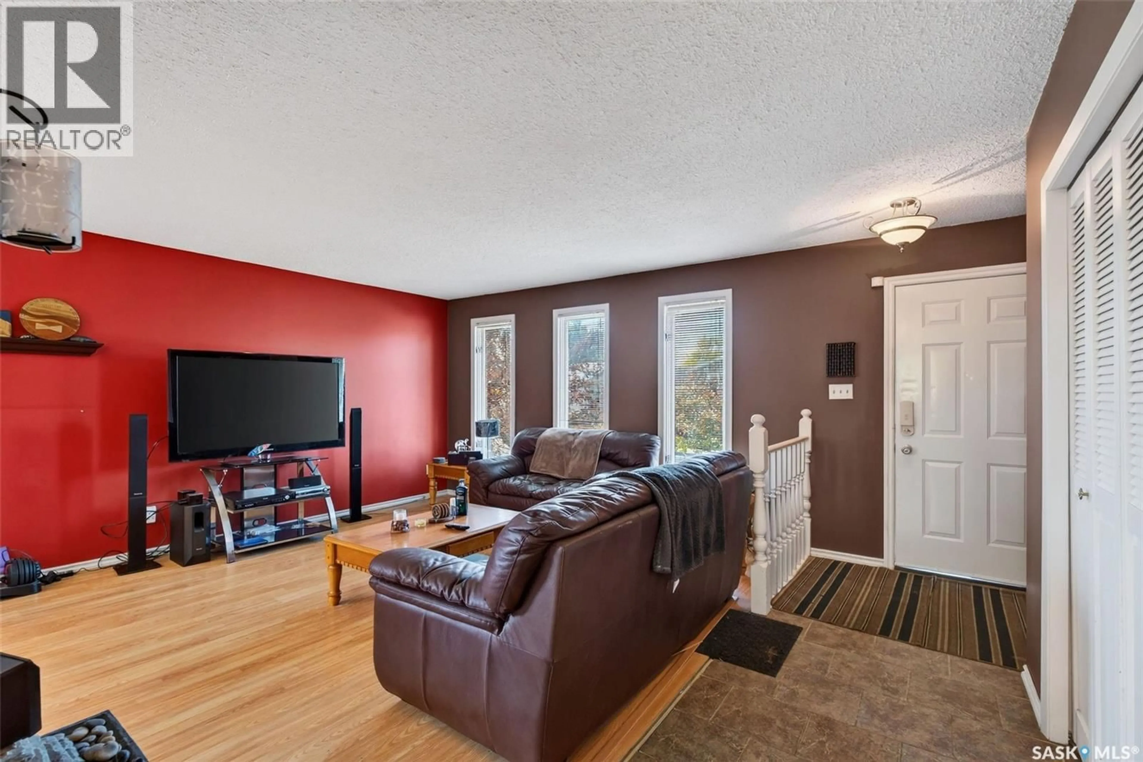 Living room with furniture, wood/laminate floor for 3458 EAGLE CRESCENT, Prince Albert Saskatchewan S6V7W9