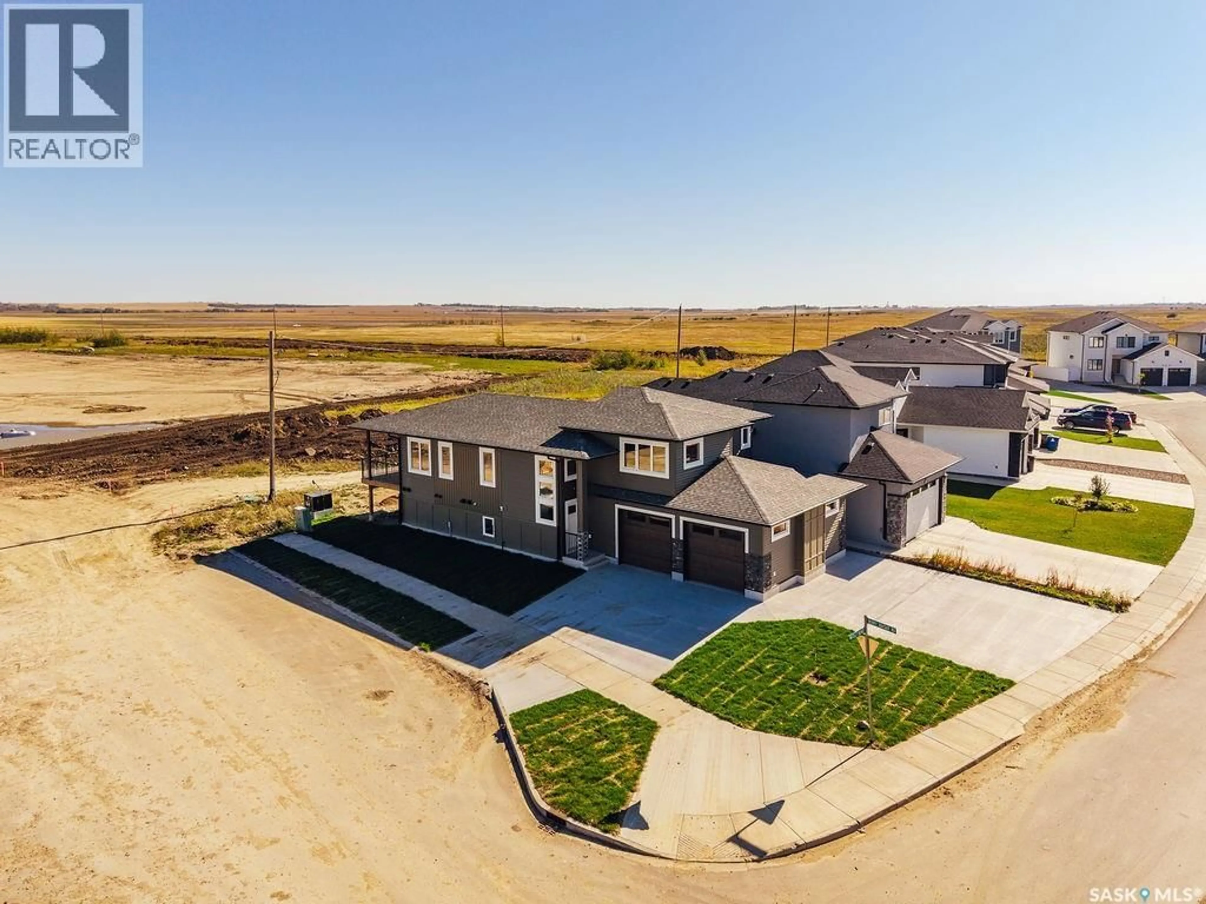 A pic from outside/outdoor area/front of a property/back of a property/a pic from drone, street for 492 WOOLF BEND, Saskatoon Saskatchewan S7W1E4