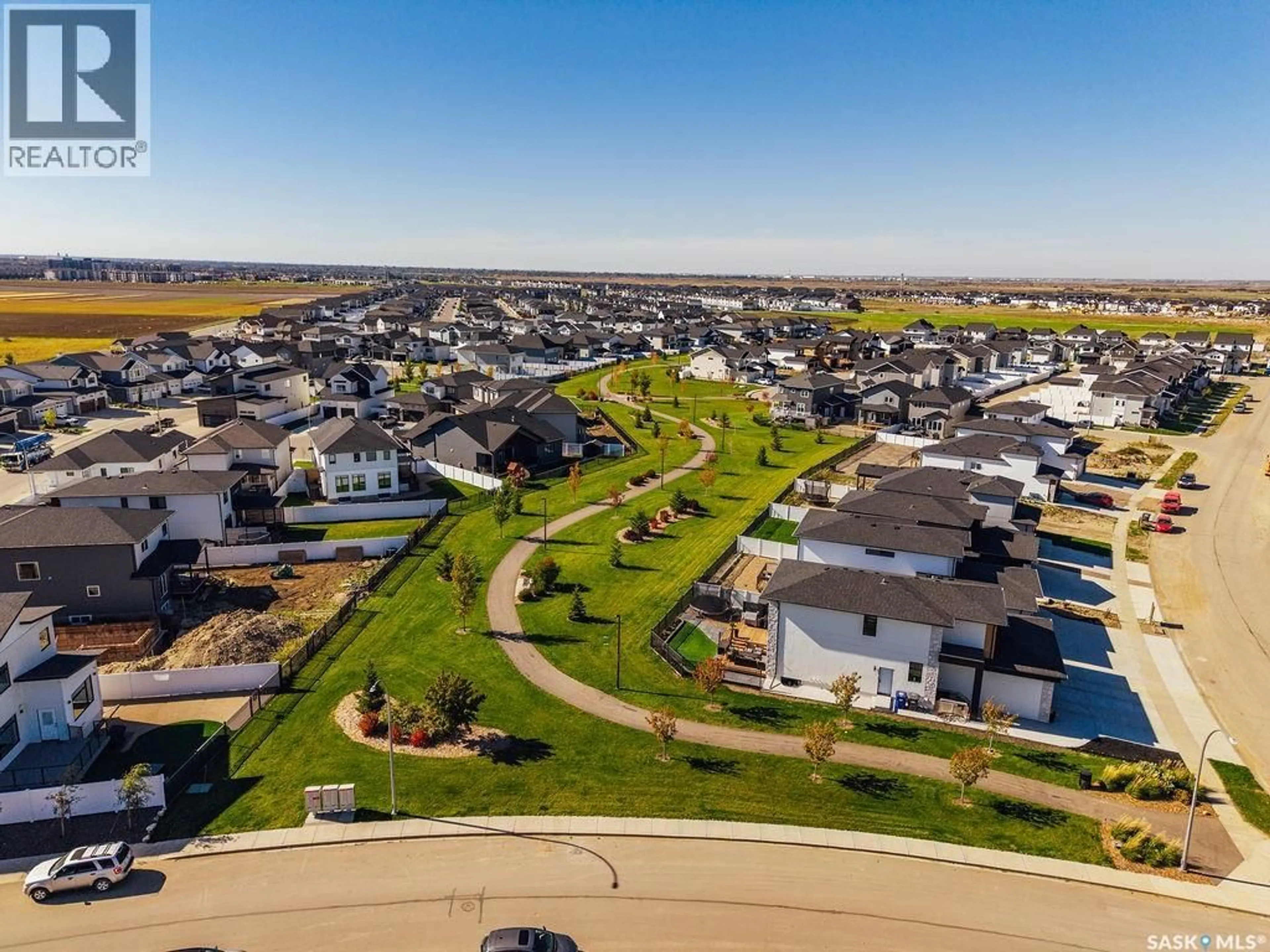 A pic from outside/outdoor area/front of a property/back of a property/a pic from drone, street for 492 WOOLF BEND, Saskatoon Saskatchewan S7W1E4