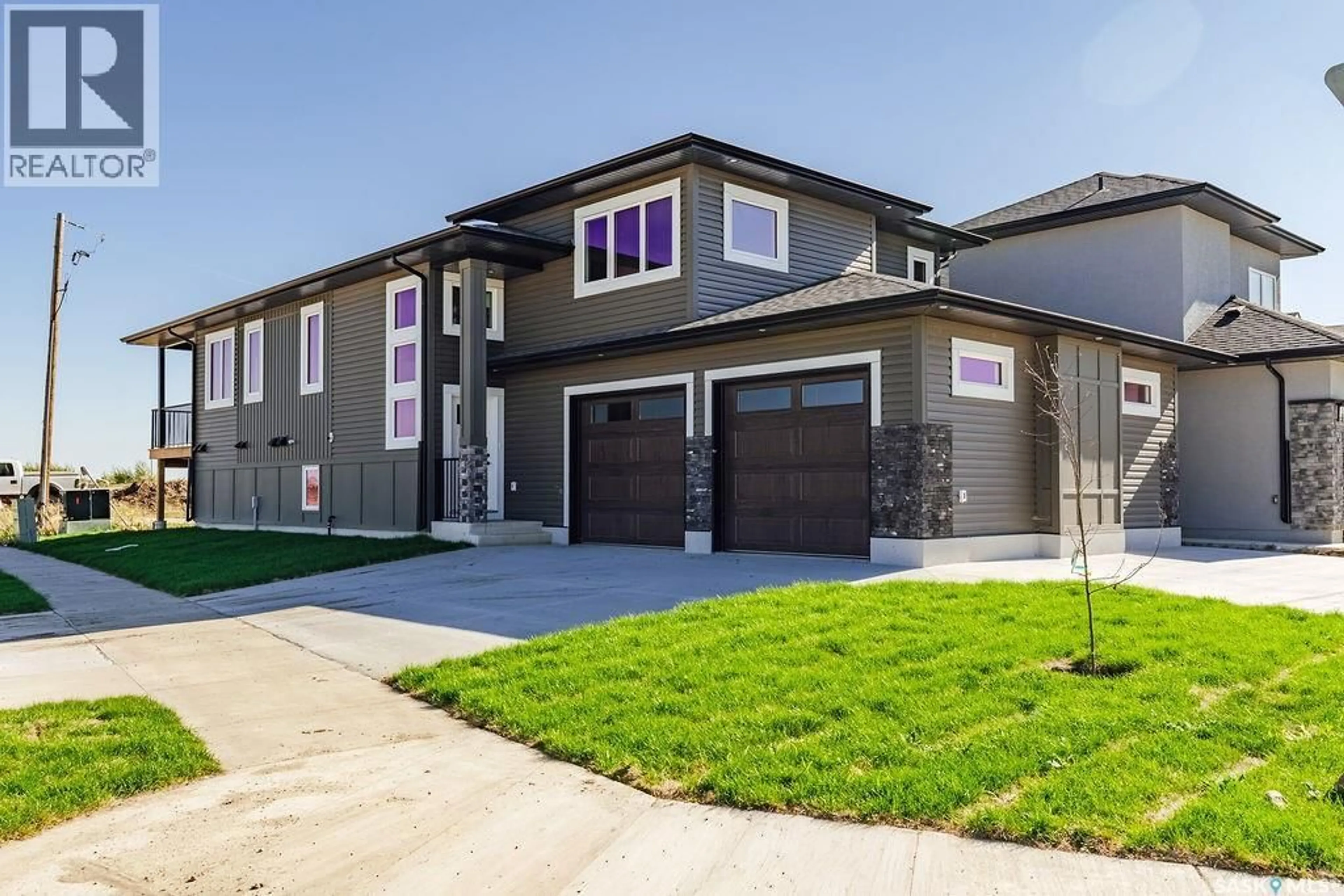 Home with vinyl exterior material, street for 492 WOOLF BEND, Saskatoon Saskatchewan S7W1E4