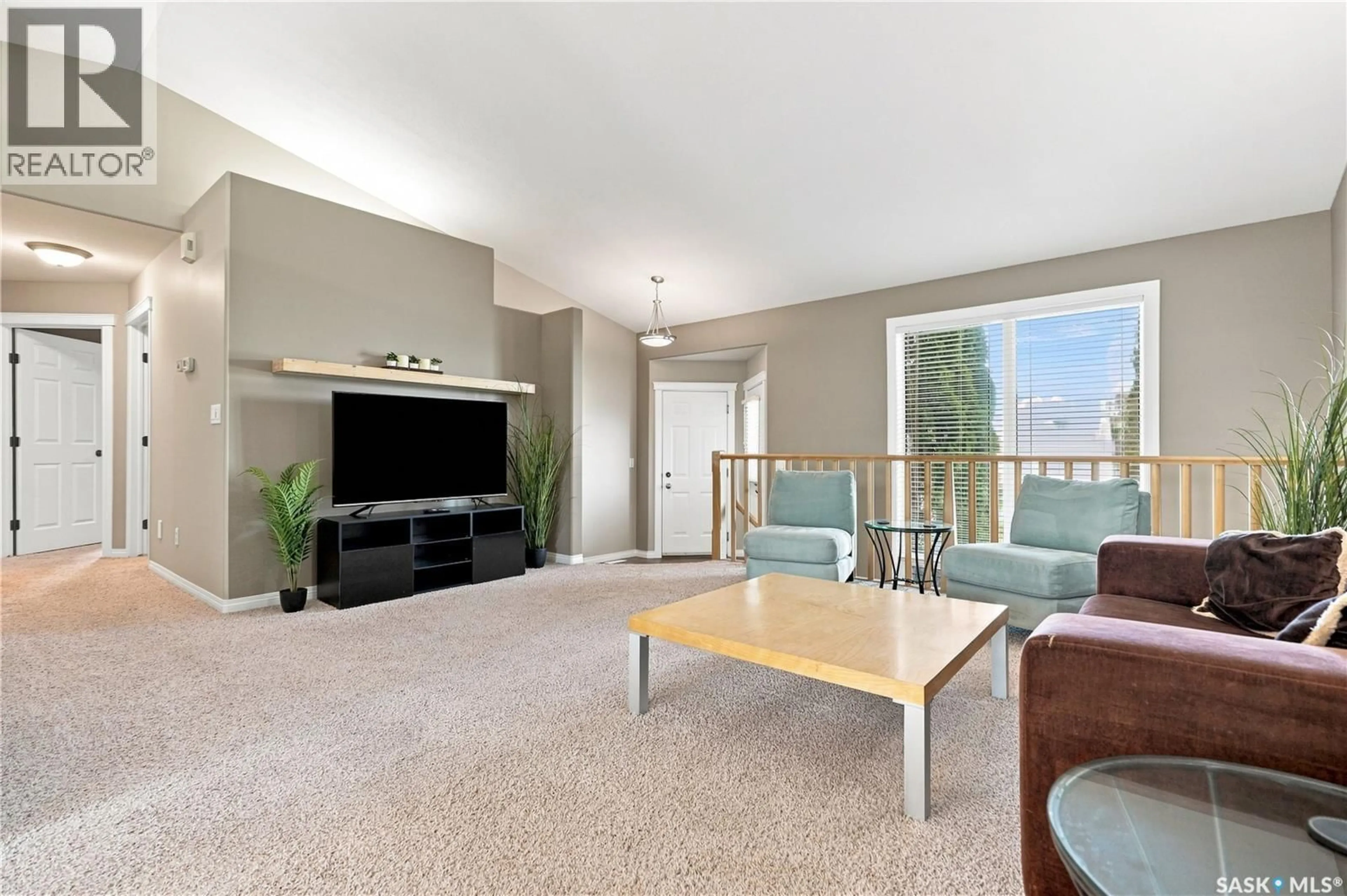 Living room with furniture, carpet floor for 410 BOURGONJE COURT, Saskatoon Saskatchewan S7S1L7