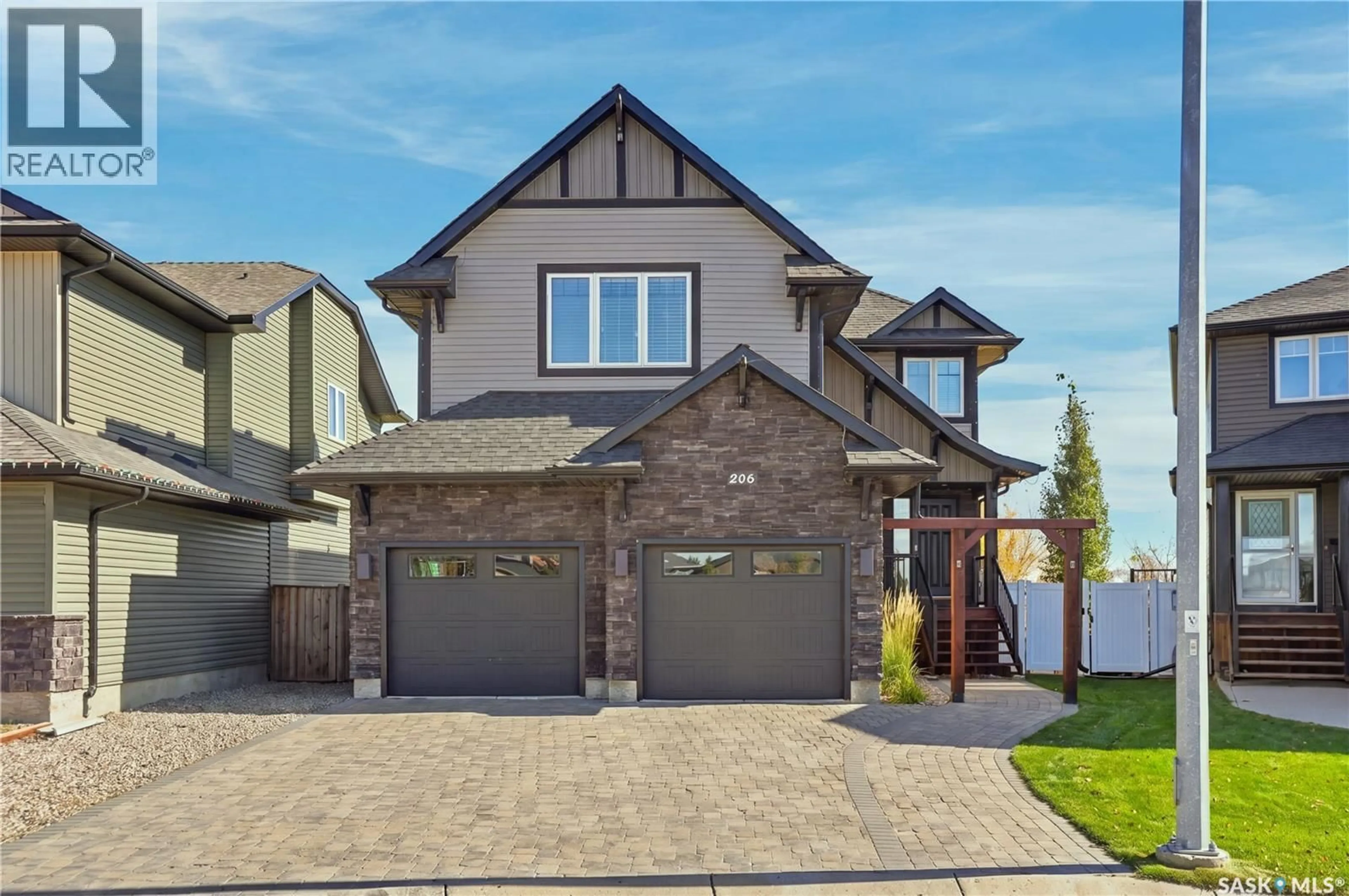 Home with brick exterior material, street for 206 PARKVIEW COVE, Osler Saskatchewan S0K3A0
