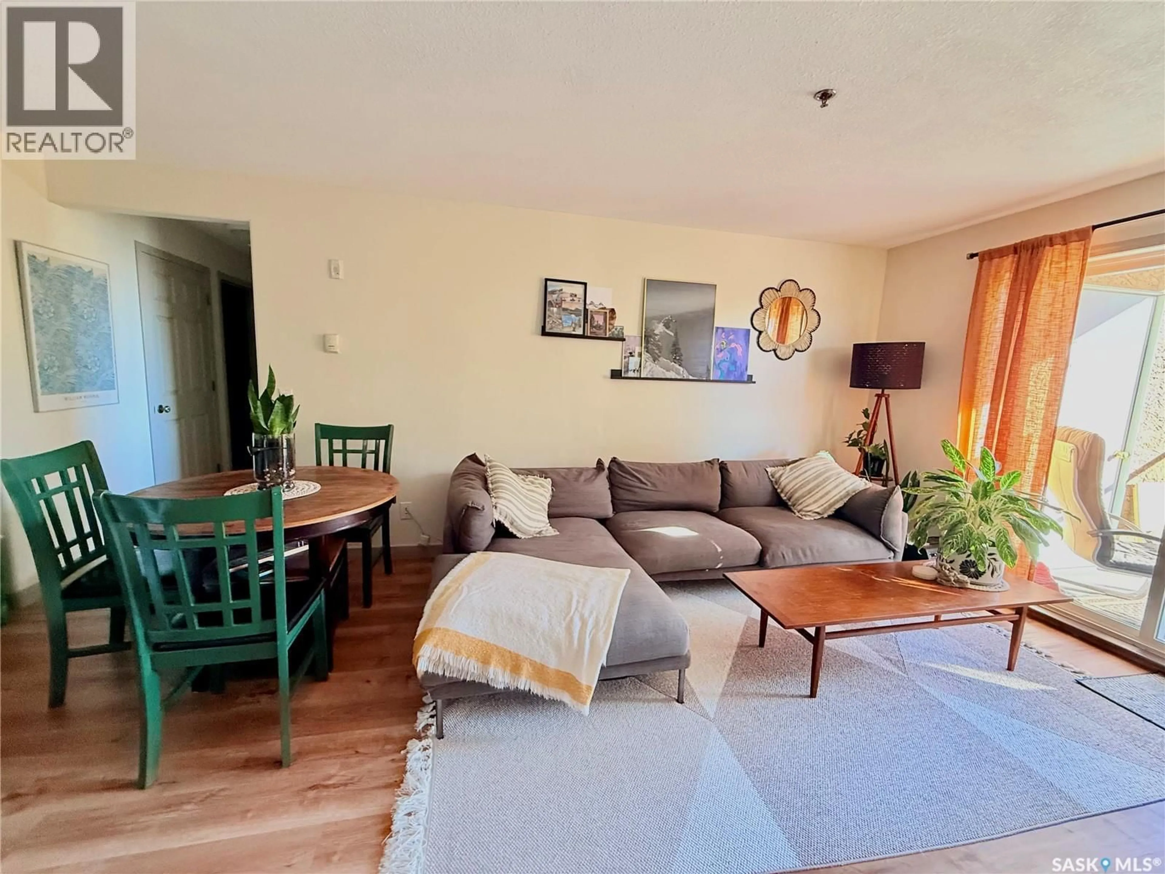 Living room with furniture, wood/laminate floor for 311 215 LOWE ROAD, Saskatoon Saskatchewan S7S1N1