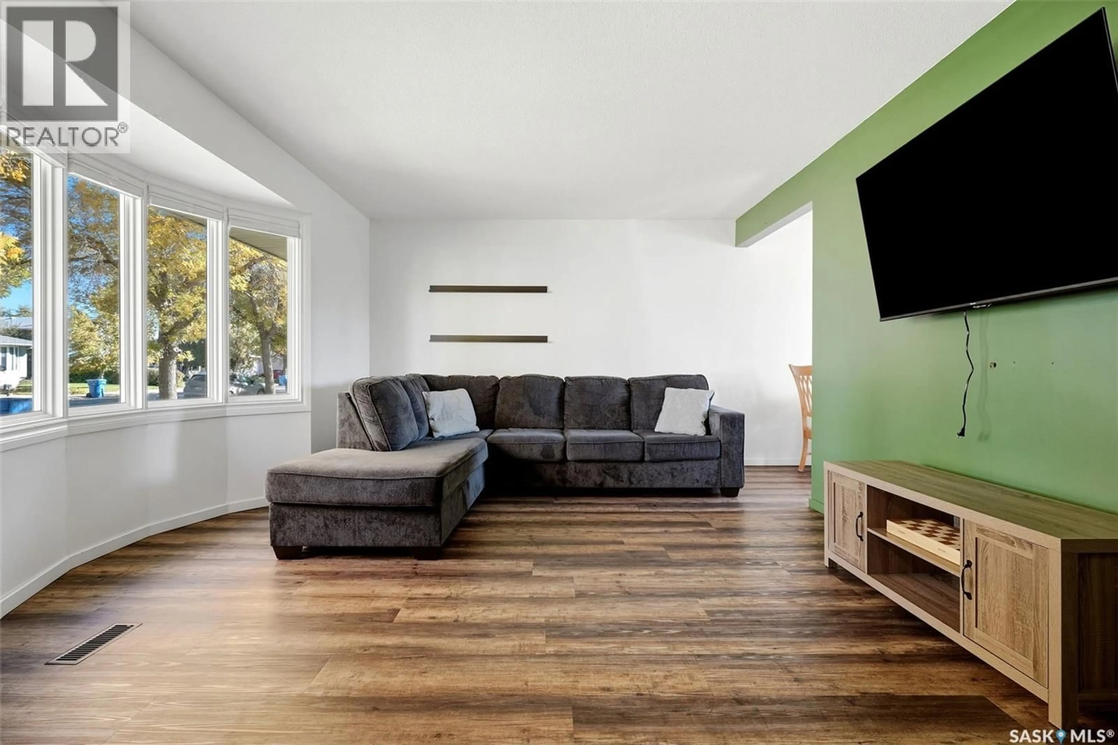 Living room with furniture, wood/laminate floor for 147 RINK AVENUE, Regina Saskatchewan S4R5W2