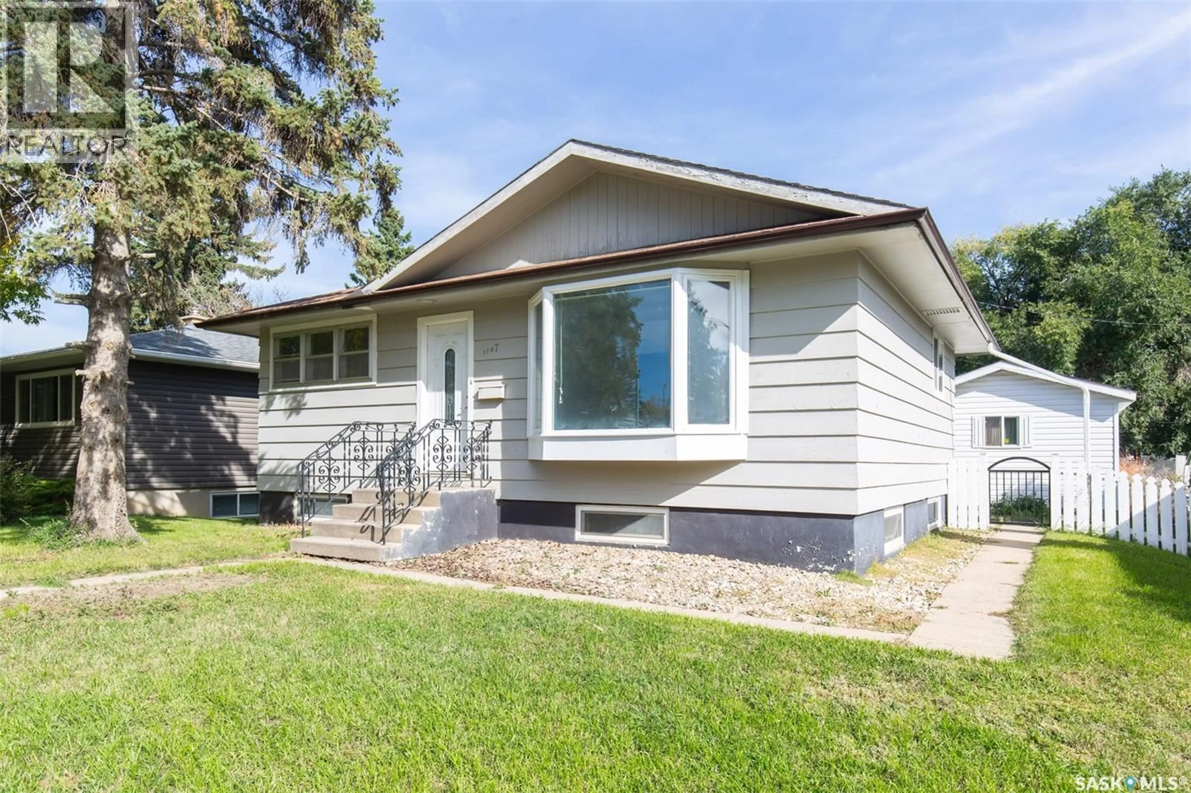 Home with vinyl exterior material, street for 1147 MAIN STREET, Moose Jaw Saskatchewan S6H0X3