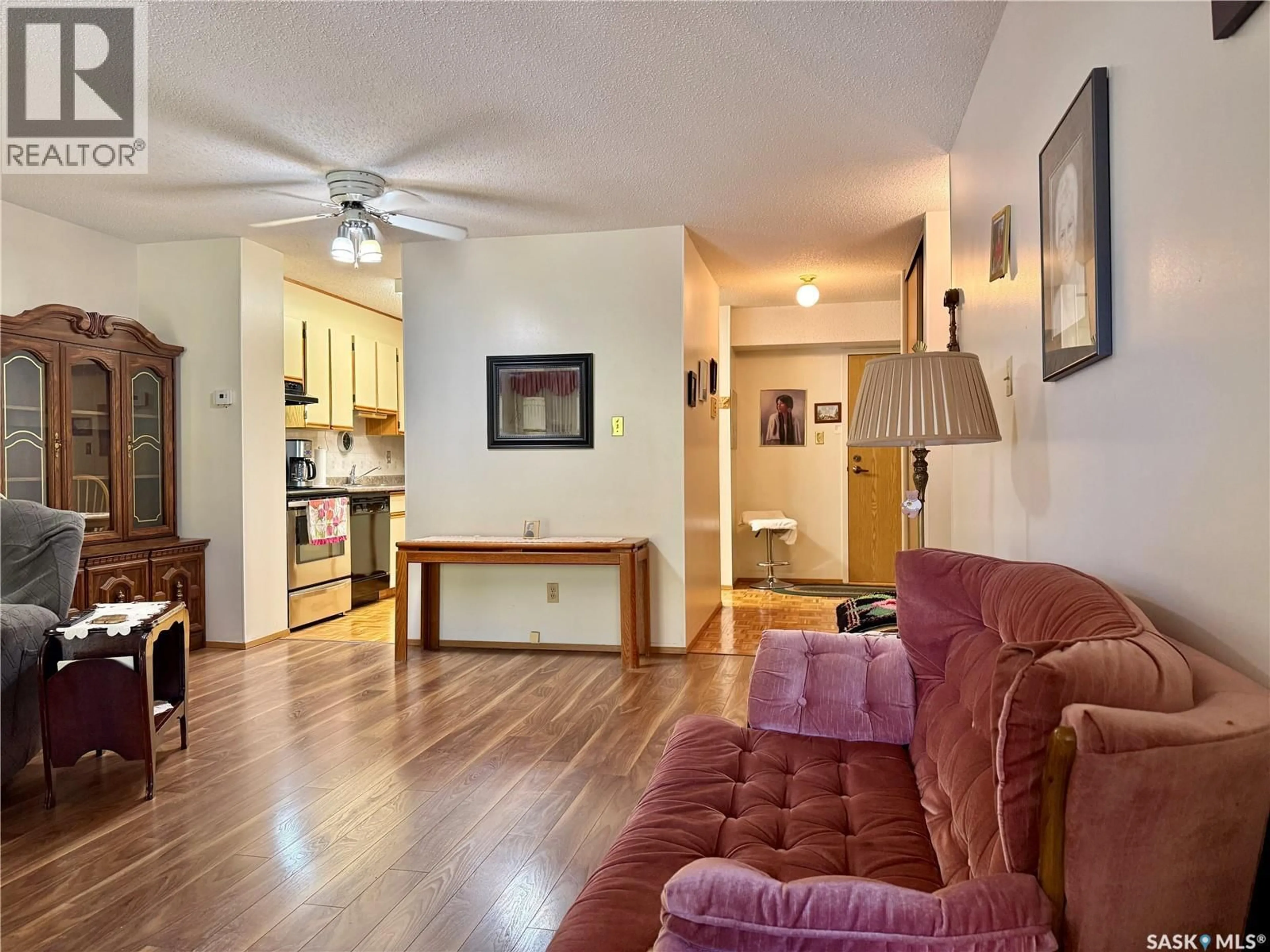 Living room with furniture, wood/laminate floor for 305 - 525 5TH AVENUE N, Saskatoon Saskatchewan S7K2R1