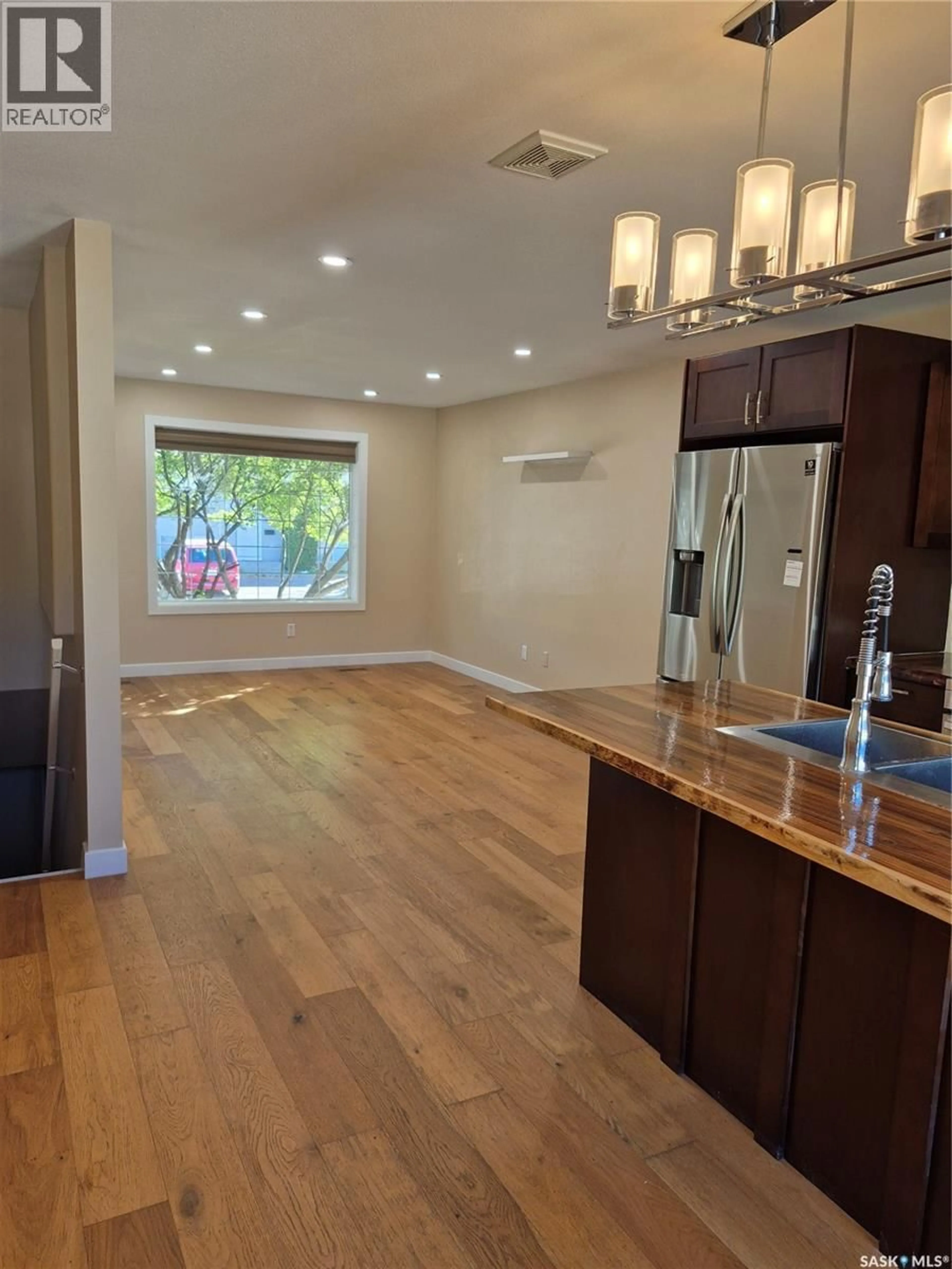 Open concept kitchen, wood/laminate floor for 21 143 GROPPER CRESCENT, Saskatoon Saskatchewan S7M5W2