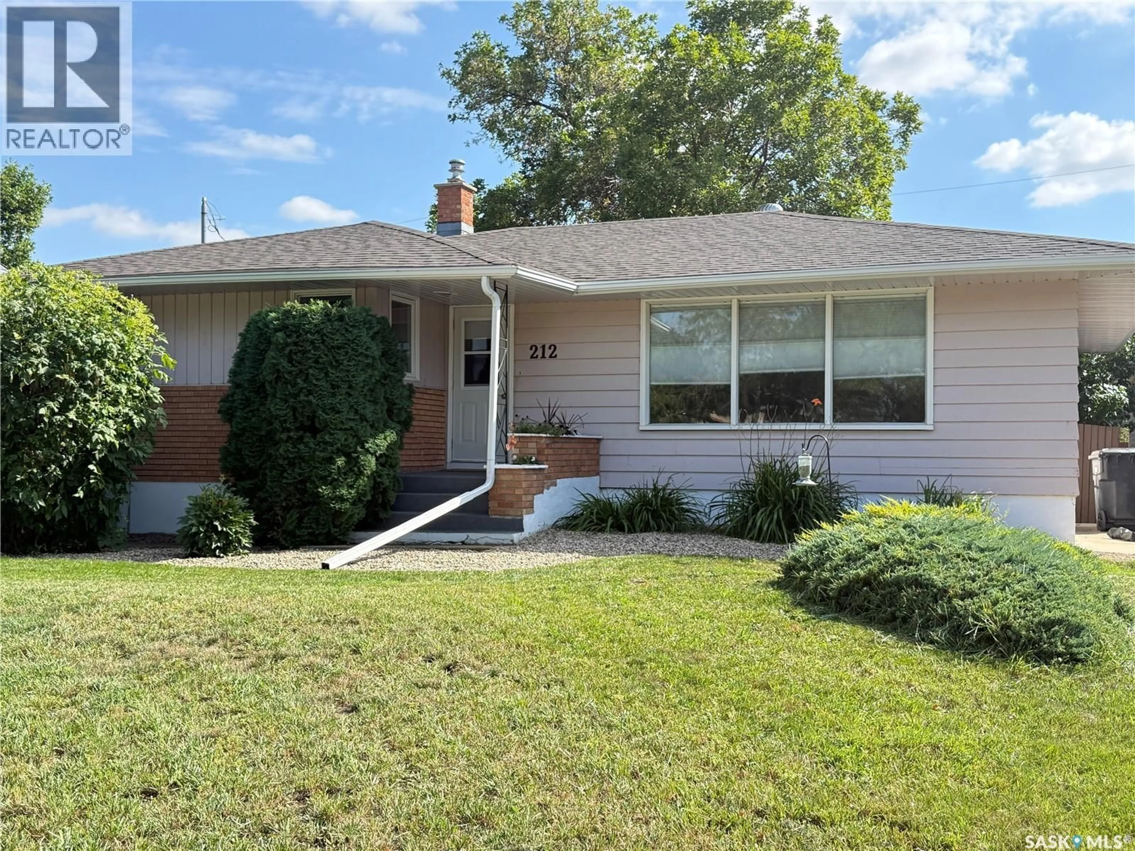 Home with vinyl exterior material, street for 212 ASH DRIVE, Weyburn Saskatchewan S4H0S2