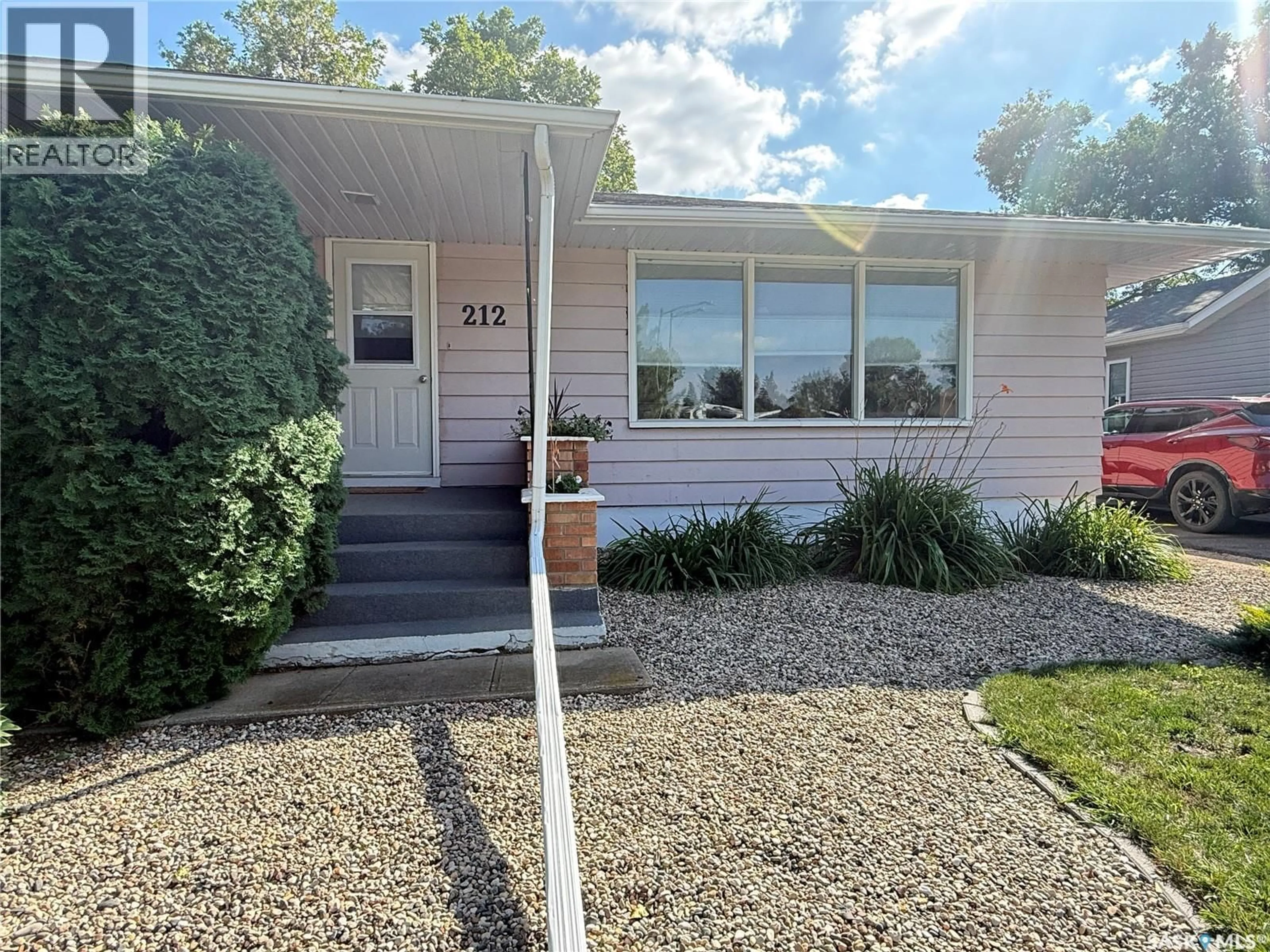Home with vinyl exterior material, street for 212 ASH DRIVE, Weyburn Saskatchewan S4H0S2