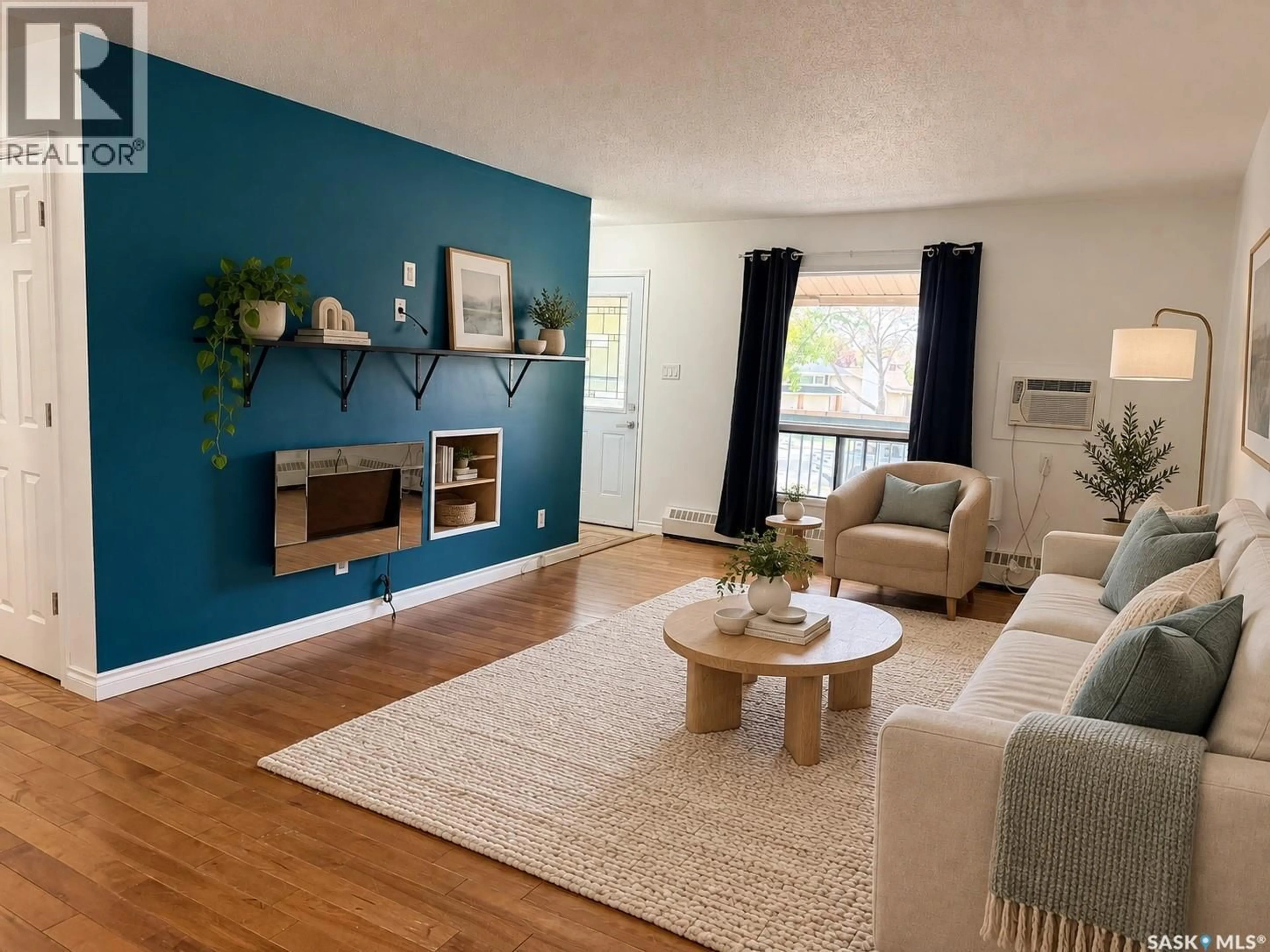 Living room with furniture, wood/laminate floor for 54B NOLLET AVENUE, Regina Saskatchewan S4T7P9