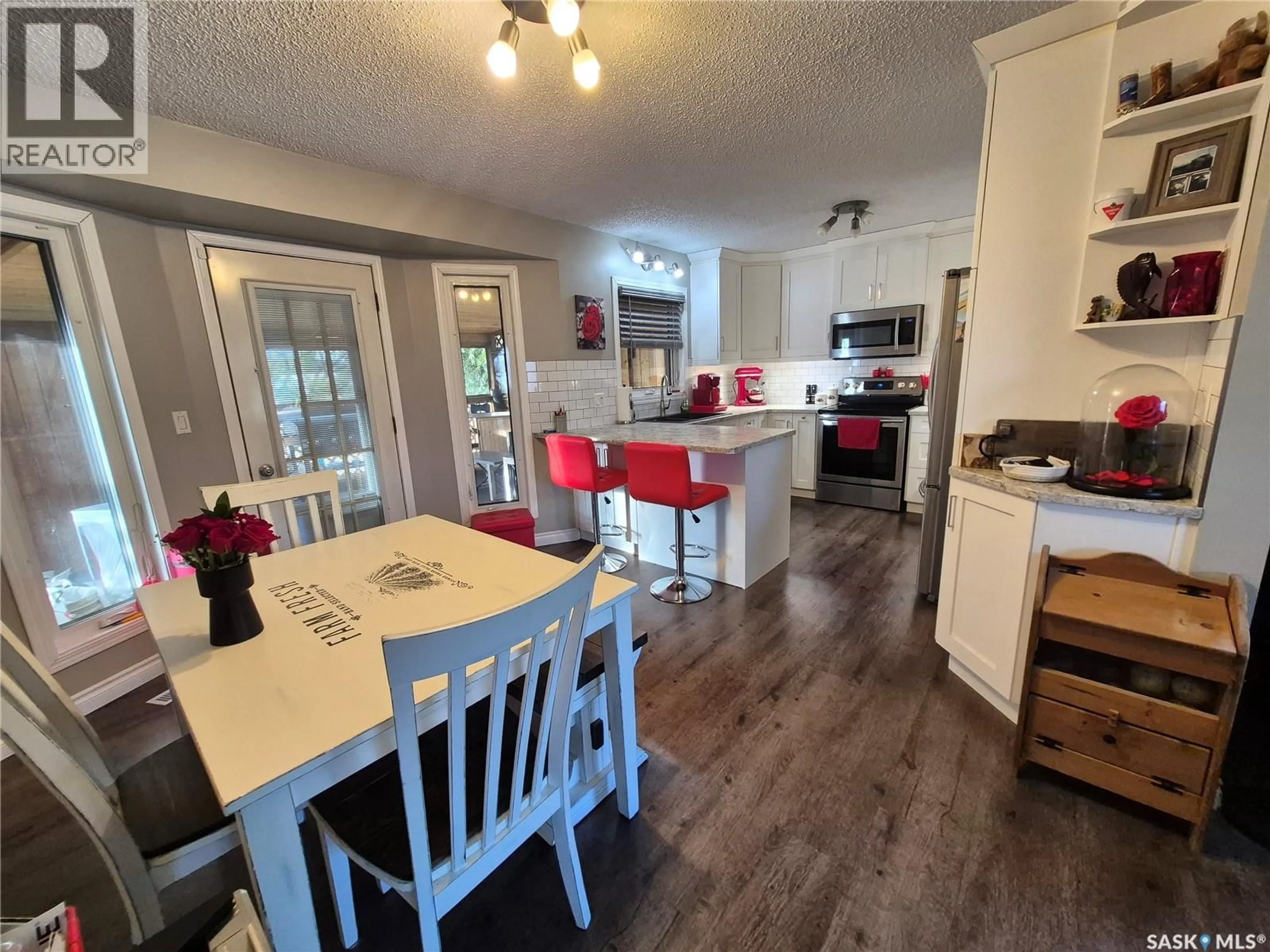 Open concept kitchen, wood/laminate floor for 221 BEAN CRESCENT, Weyburn Saskatchewan S4H3A3