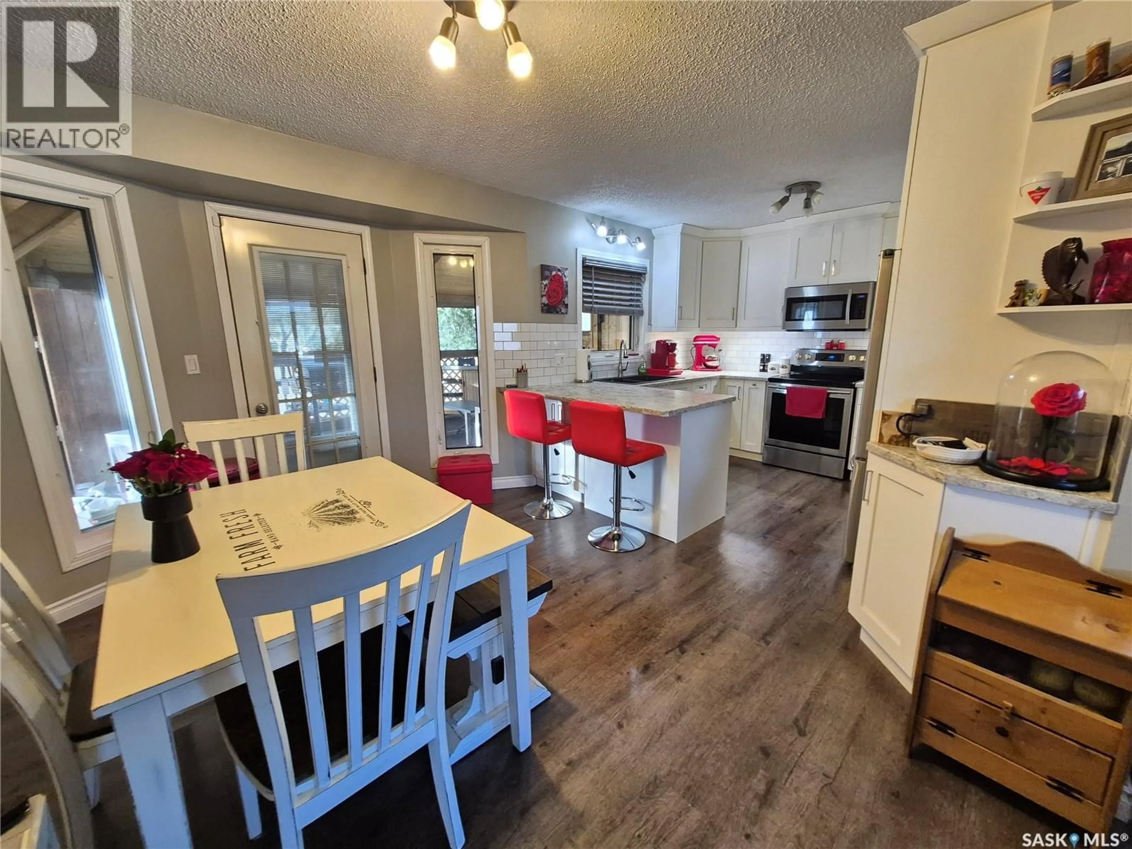 Open concept kitchen, wood/laminate floor for 221 BEAN CRESCENT, Weyburn Saskatchewan S4H3A3