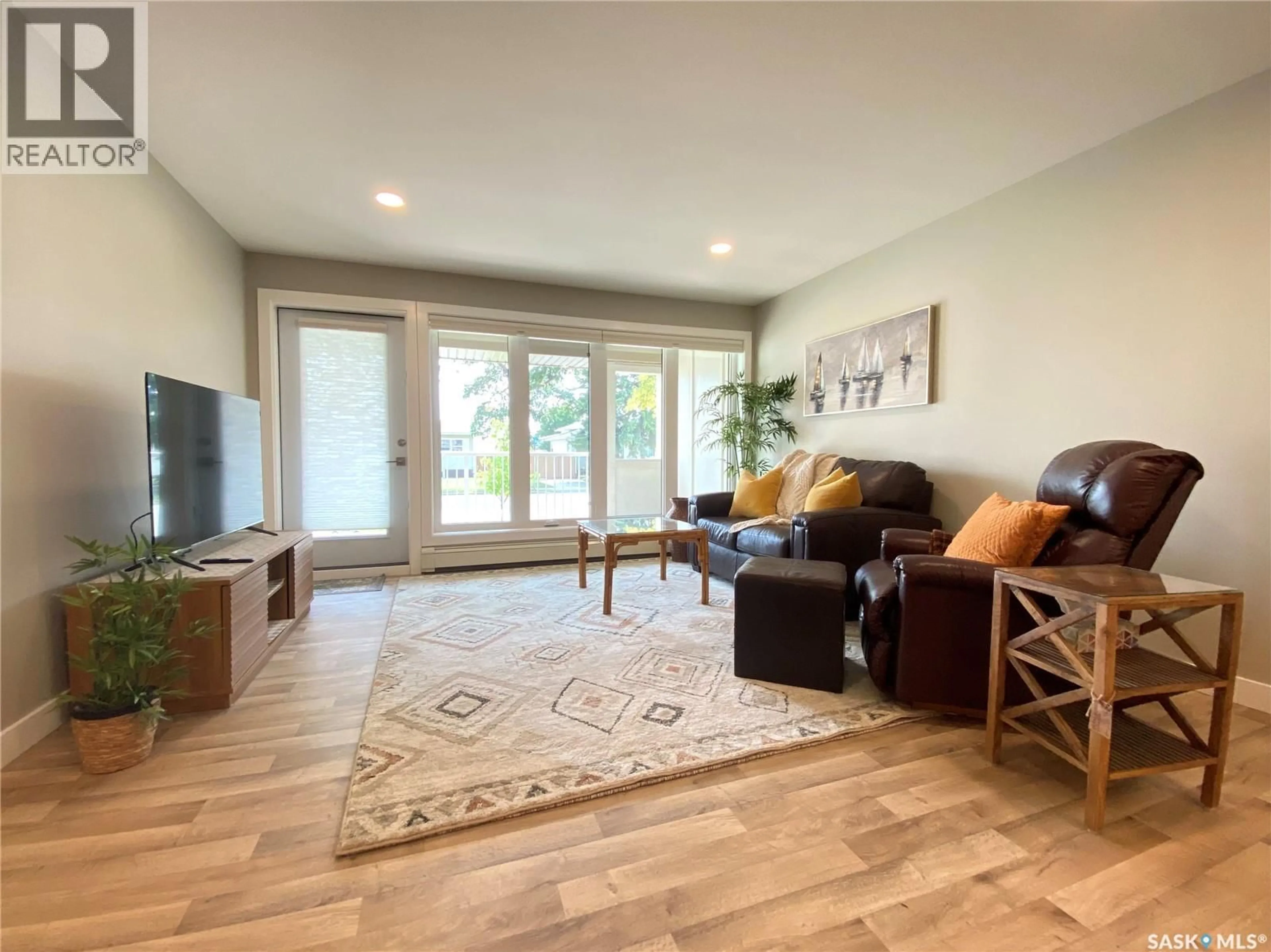 Living room with furniture, wood/laminate floor for 105 - 318 108TH STREET, Saskatoon Saskatchewan S7N1P8