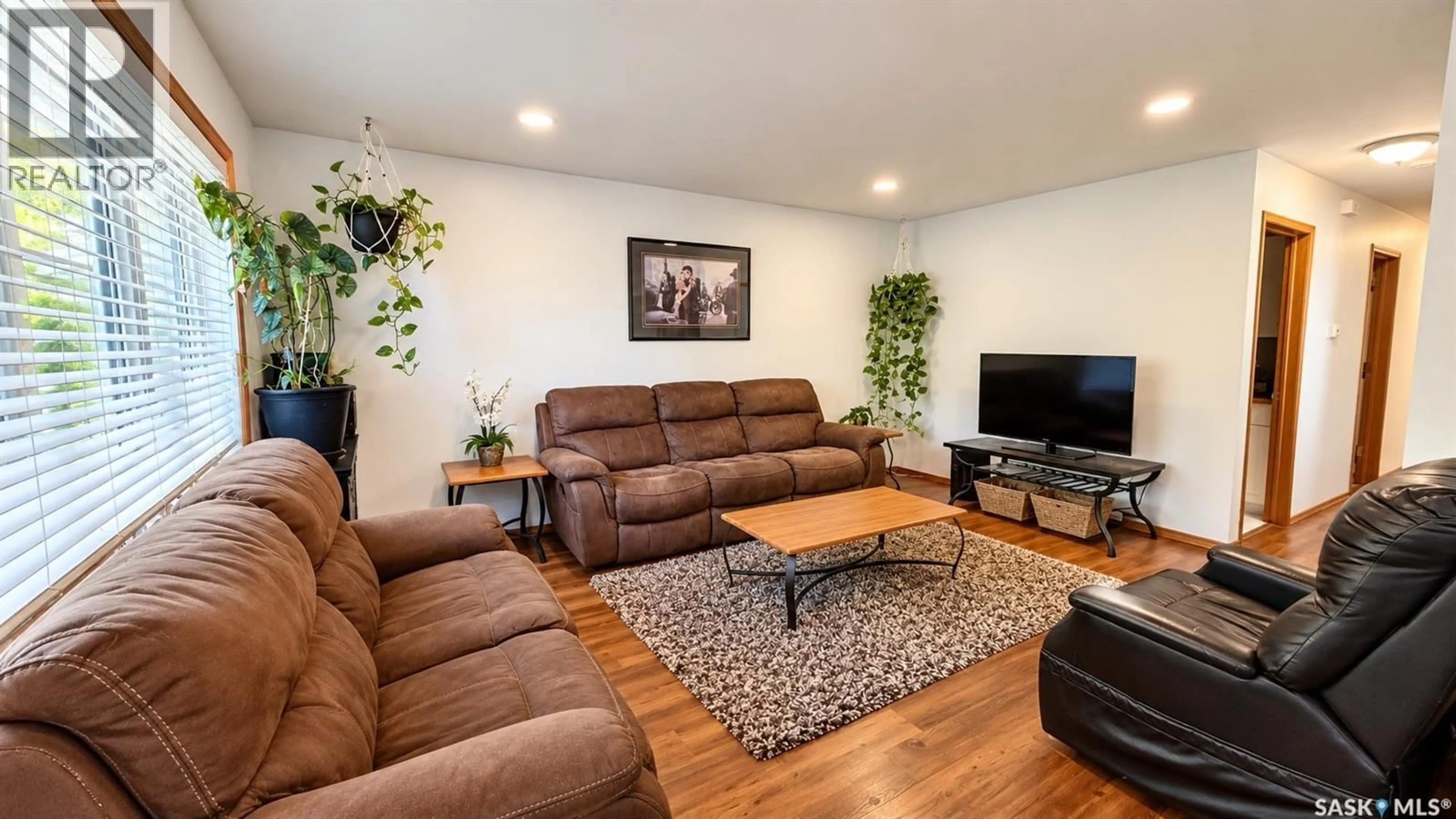 Living room with furniture, wood/laminate floor for 717 31ST STREET, Saskatoon Saskatchewan S7L0R5