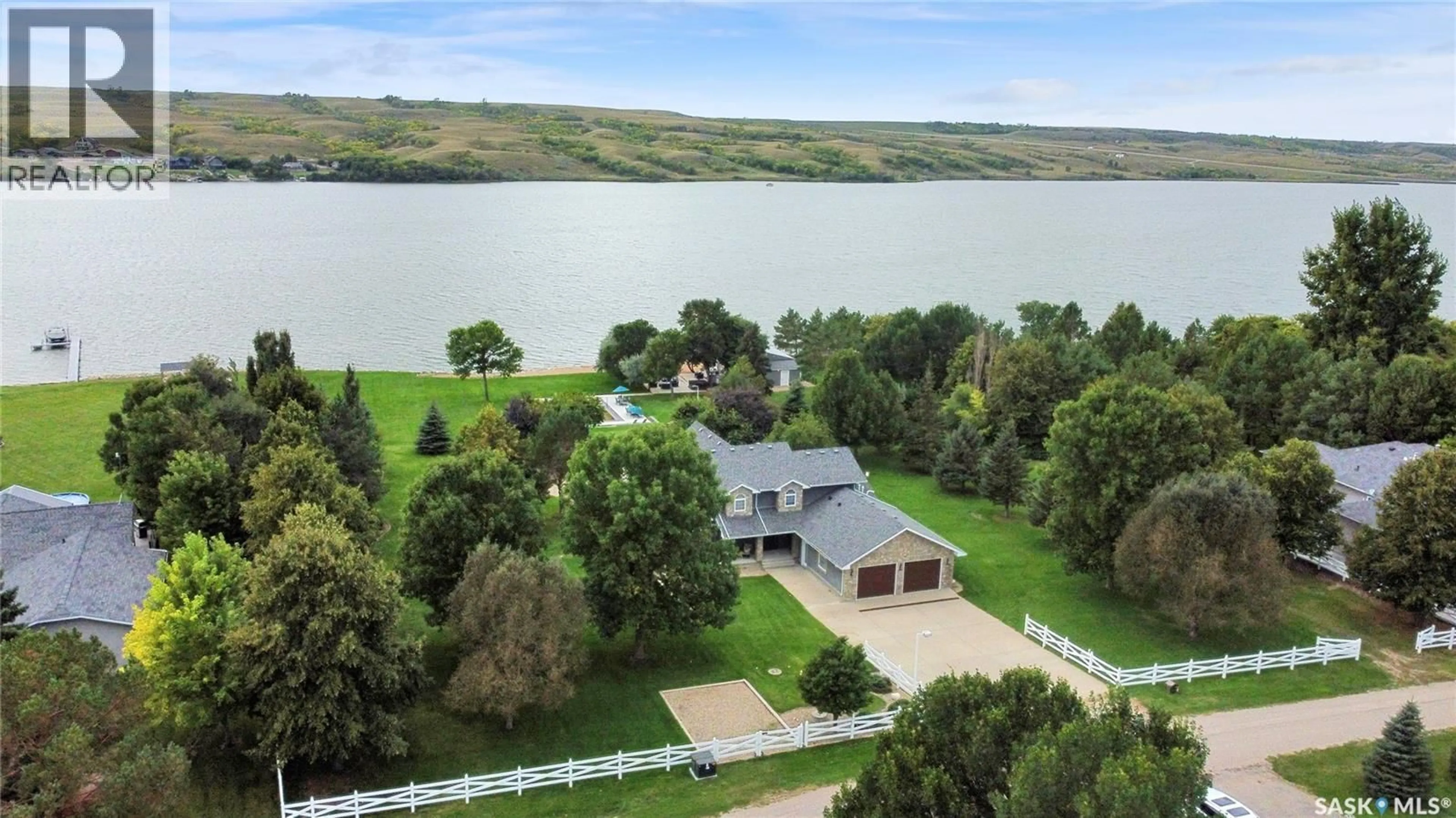 A pic from outside/outdoor area/front of a property/back of a property/a pic from drone, water/lake/river/ocean view for 203 NORTH SHORE DRIVE, North Grove Saskatchewan S0G1P0